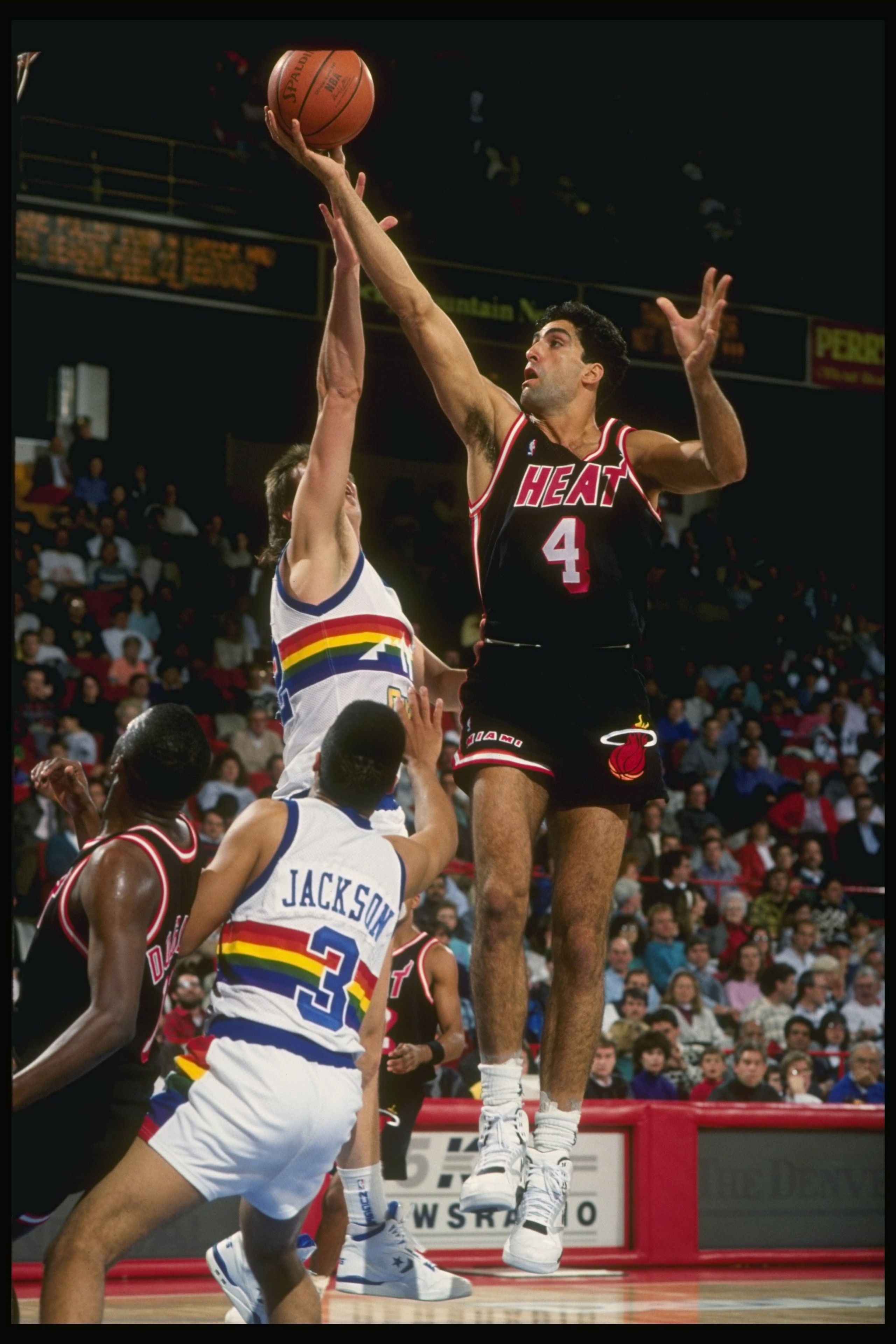 1989:  Center Rony Seikaly of the Miami Heat (right) goes up for the layup past center Joe Wolf and guard Chris Jackson of the Denver Nuggets during a game at the McNichols Arena in Denver, Colorado. Mandatory Credit: Tim de Frisco  /Allsport