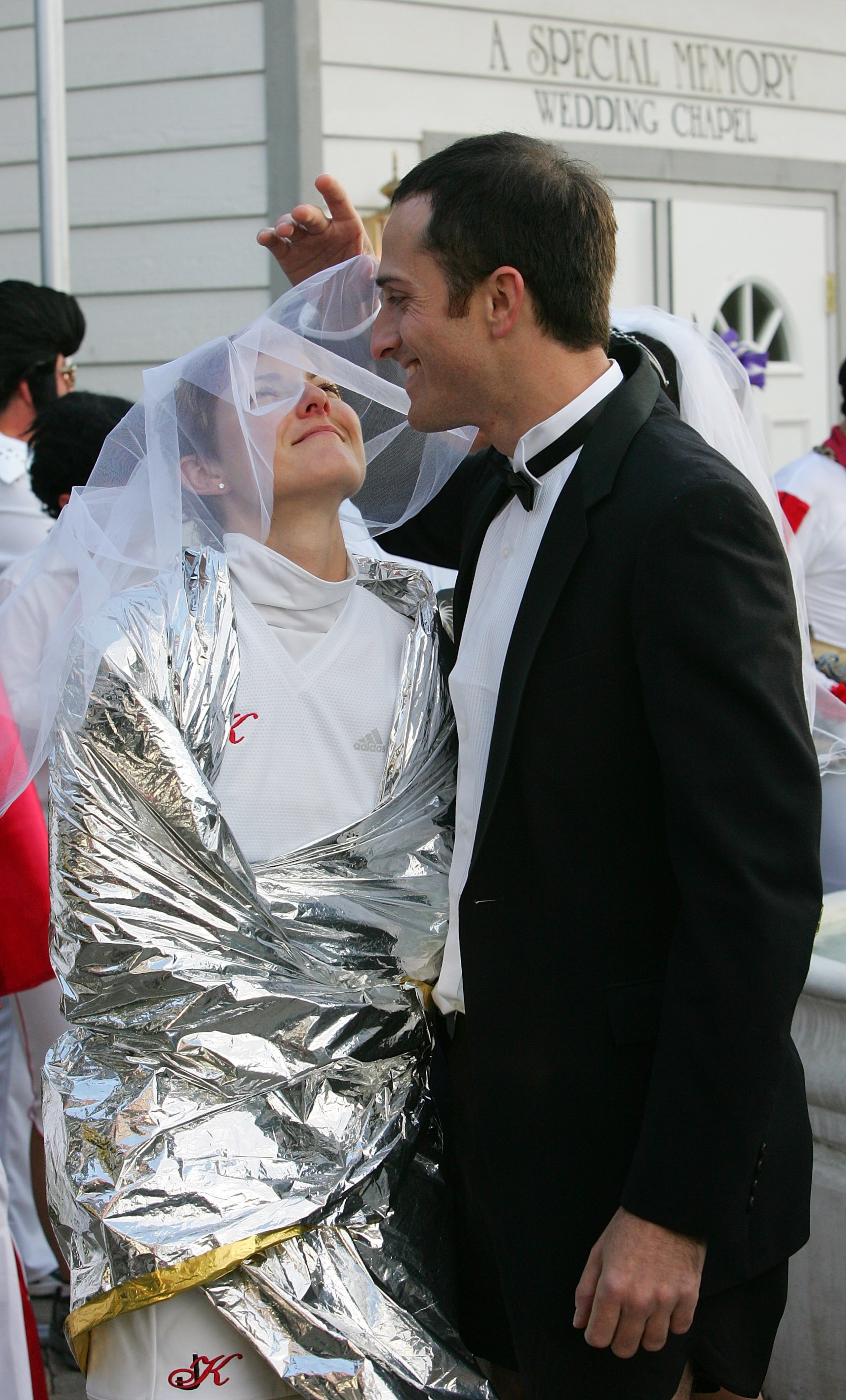 LAS VEGAS - DECEMBER 10: Jason Thomas of Georgia fixes Kimberly Engle's veil as the Georgia couple is married at A Special Memory Wedding Chapel during the second annual New Las Vegas Marathon December 10, 2006 in Las Vegas, Nevada. More than 20 couples LAS VEGAS - DECEMBER 10: Jason Thomas of Georgia fixes Kimberly Engle's veil as the Georgia couple is married at A Special Memory Wedding Chapel during the second annual New Las Vegas Marathon December 10, 2006 in Las Vegas, Nevada. More than 20 couples