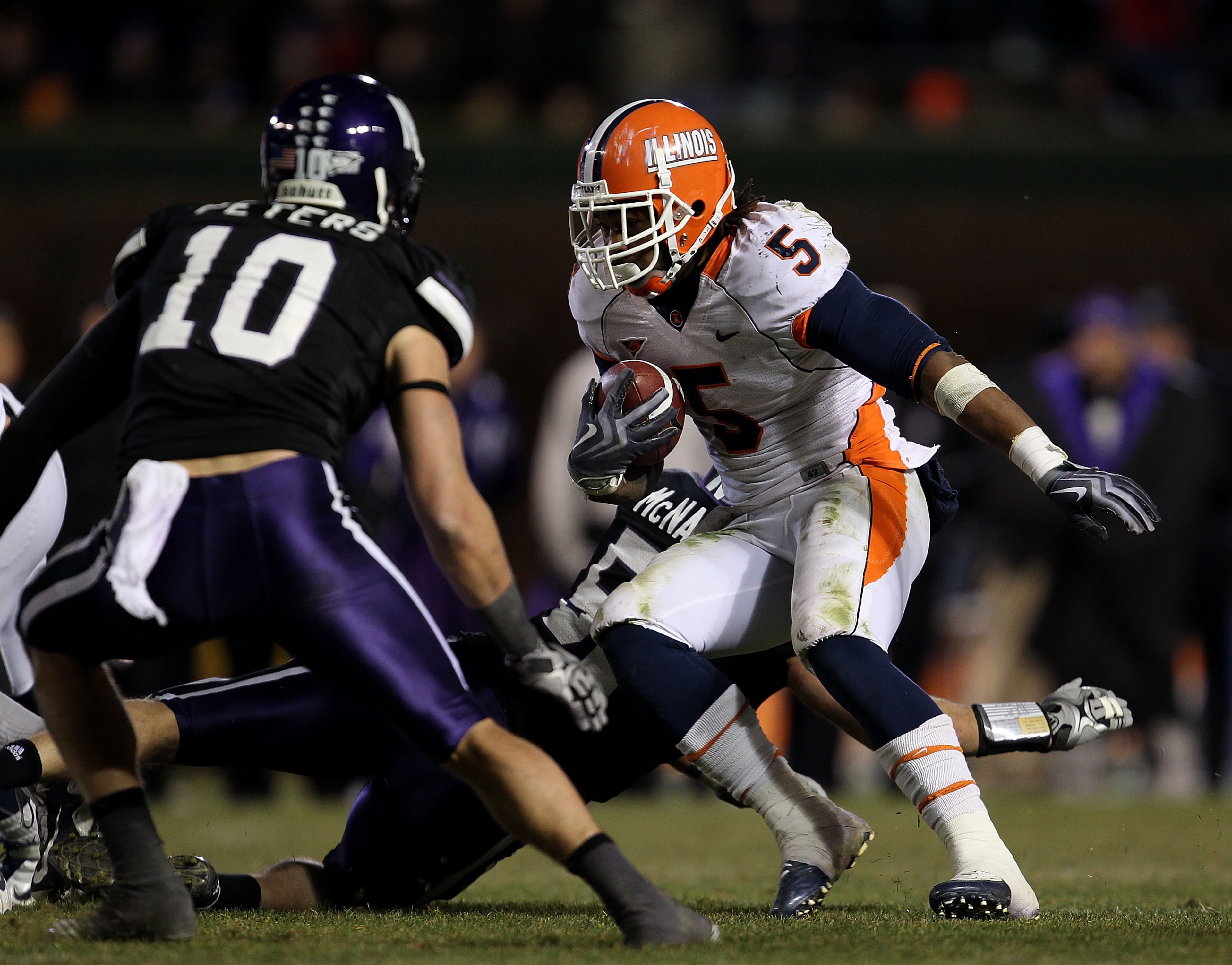 CHICAGO - NOVEMBER 20: Mikel Leshoure #5 of the Illinois Fighting Illini runs as Brian Peters #10 of the Northwestern Wildcats closes in during a game played at Wrigley Field on November 20, 2010 in Chicago, Illinois. Illinois defeated Northwestern 48-27. CHICAGO - NOVEMBER 20: Mikel Leshoure #5 of the Illinois Fighting Illini runs as Brian Peters #10 of the Northwestern Wildcats closes in during a game played at Wrigley Field on November 20, 2010 in Chicago, Illinois. Illinois defeated Northwestern 48-27.