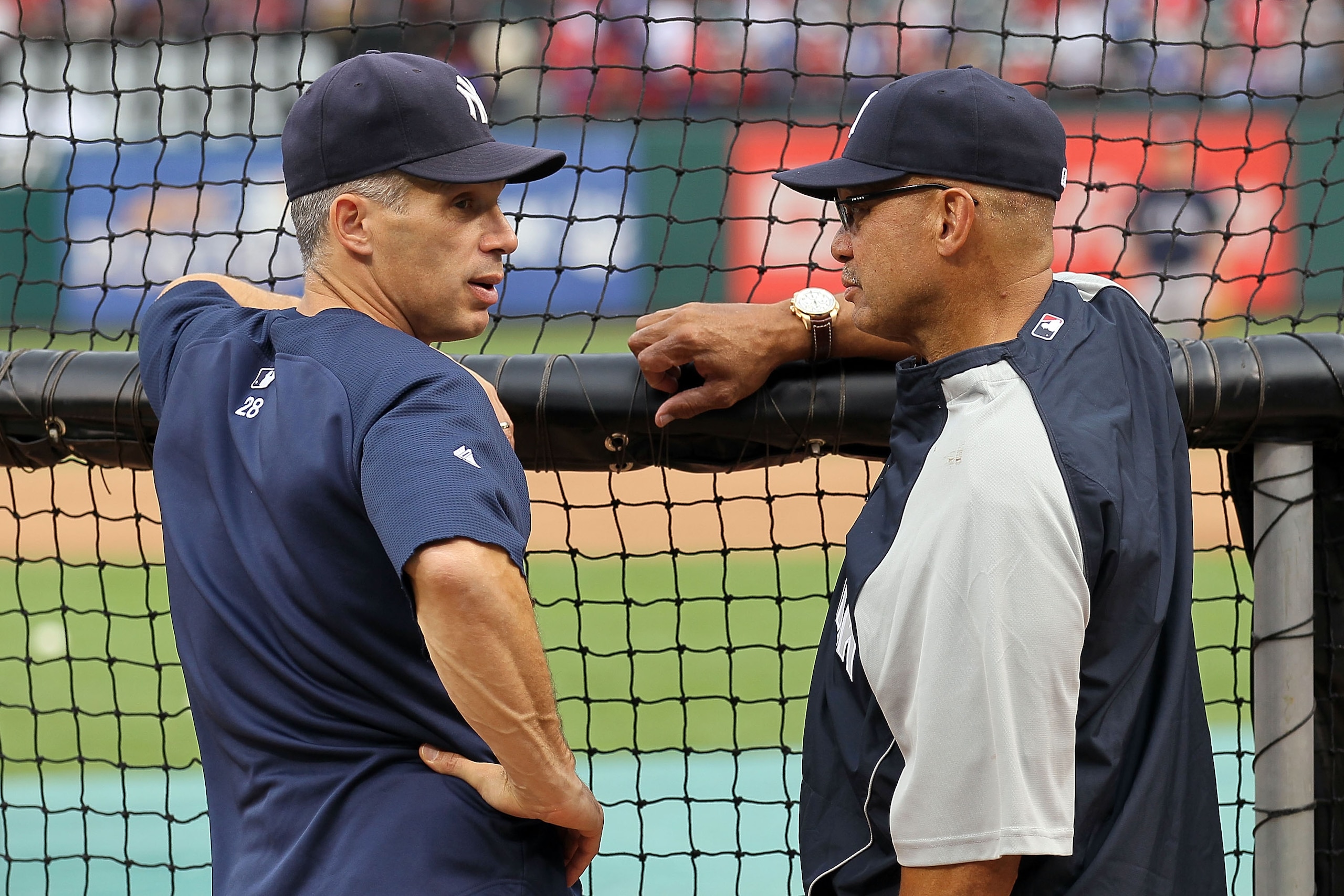 ARLINGTON, TX - OCTOBER 22:  Manager Joe Girardi of the New York Yankees talks with former Yankee and Hall of Famer Reggie Jackson during batting practice against the Texas Rangers in Game Six of the ALCS during the 2010 MLB Playoffs at Rangers Ballpark i