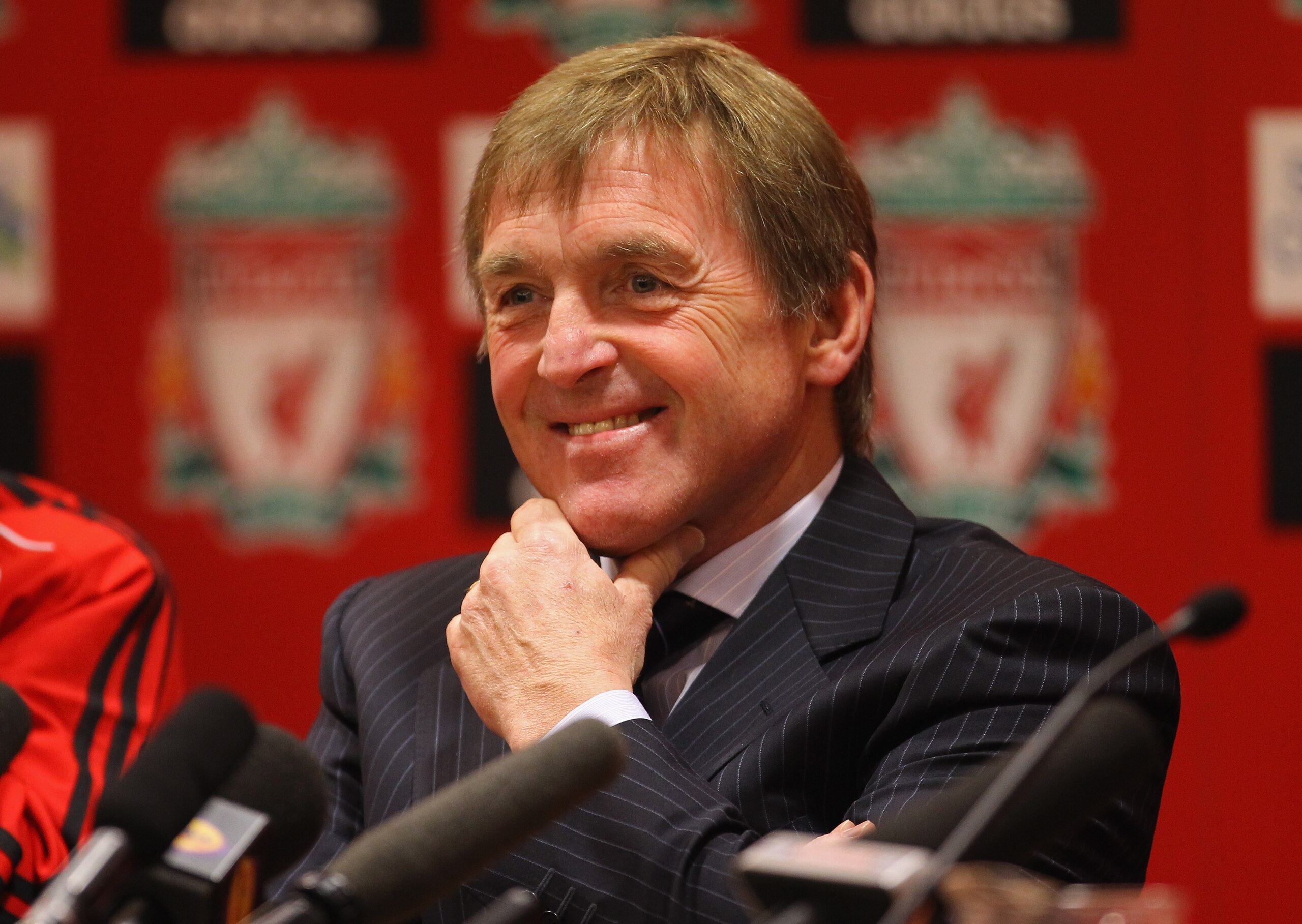 LIVERPOOL, ENGLAND - FEBRUARY 03: Kenny Dalglish the manager of Liverpool faces the media during a press conference to introduce his new signings, Luis Suarez and Andy Carroll, at Anfield on February 3, 2011 in Liverpool, England. (Photo by Alex Livesey LIVERPOOL, ENGLAND - FEBRUARY 03: Kenny Dalglish the manager of Liverpool faces the media during a press conference to introduce his new signings, Luis Suarez and Andy Carroll, at Anfield on February 3, 2011 in Liverpool, England. (Photo by Alex Livesey