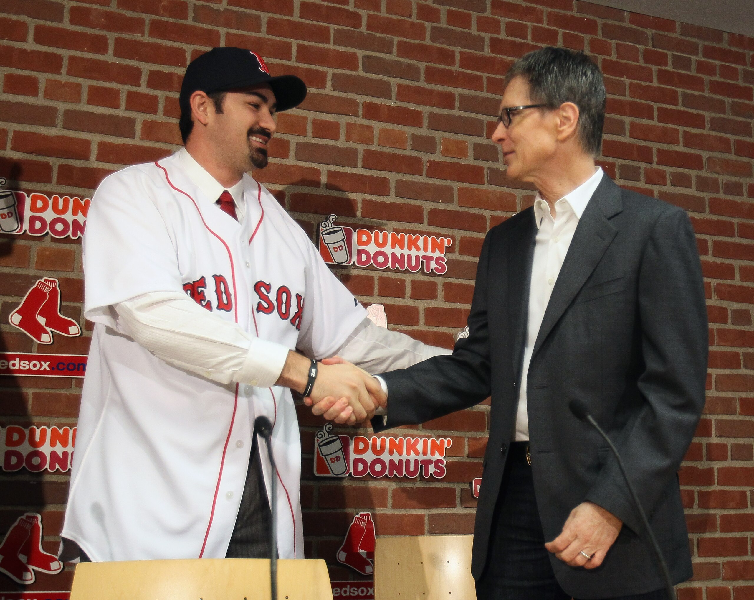 BOSTON, MA - DECEMBER 06: Adrian Gonzalez (L) shakes hands with principle owner John Henry during a press conference announcing that he signed with the Boston Red Sox on December 6, 2010 at Fenway Park in Boston, Massachusetts. (Photo by Elsa/Getty Ima BOSTON, MA - DECEMBER 06: Adrian Gonzalez (L) shakes hands with principle owner John Henry during a press conference announcing that he signed with the Boston Red Sox on December 6, 2010 at Fenway Park in Boston, Massachusetts. (Photo by Elsa/Getty Ima