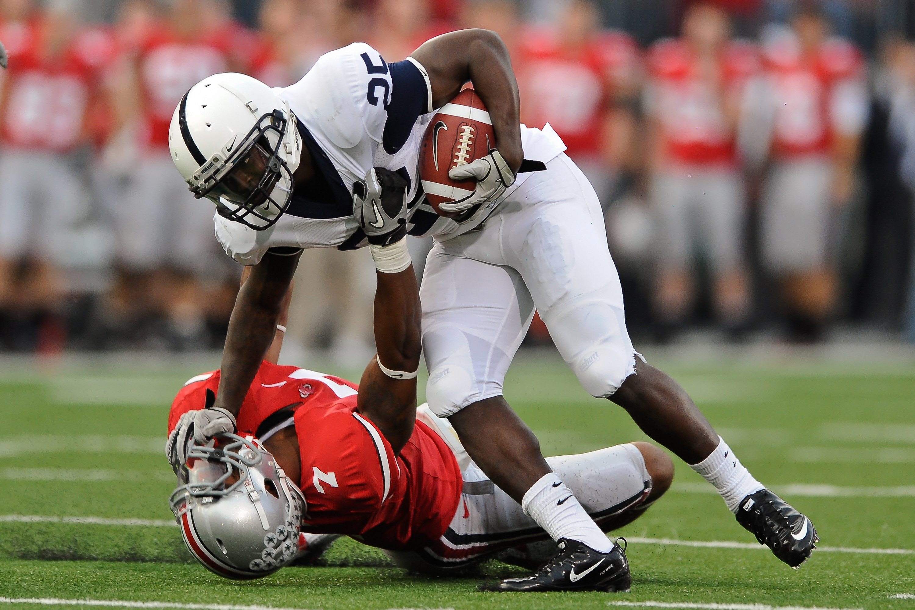 COLUMBUS, OH - NOVEMBER 13:  Silas Redd #25 of the Penn State Nittany Lions stiff arms Jermale Hines #7 of the Ohio State Buckeyes  at Ohio Stadium on November 13, 2010 in Columbus, Ohio.  (Photo by Jamie Sabau/Getty Images)