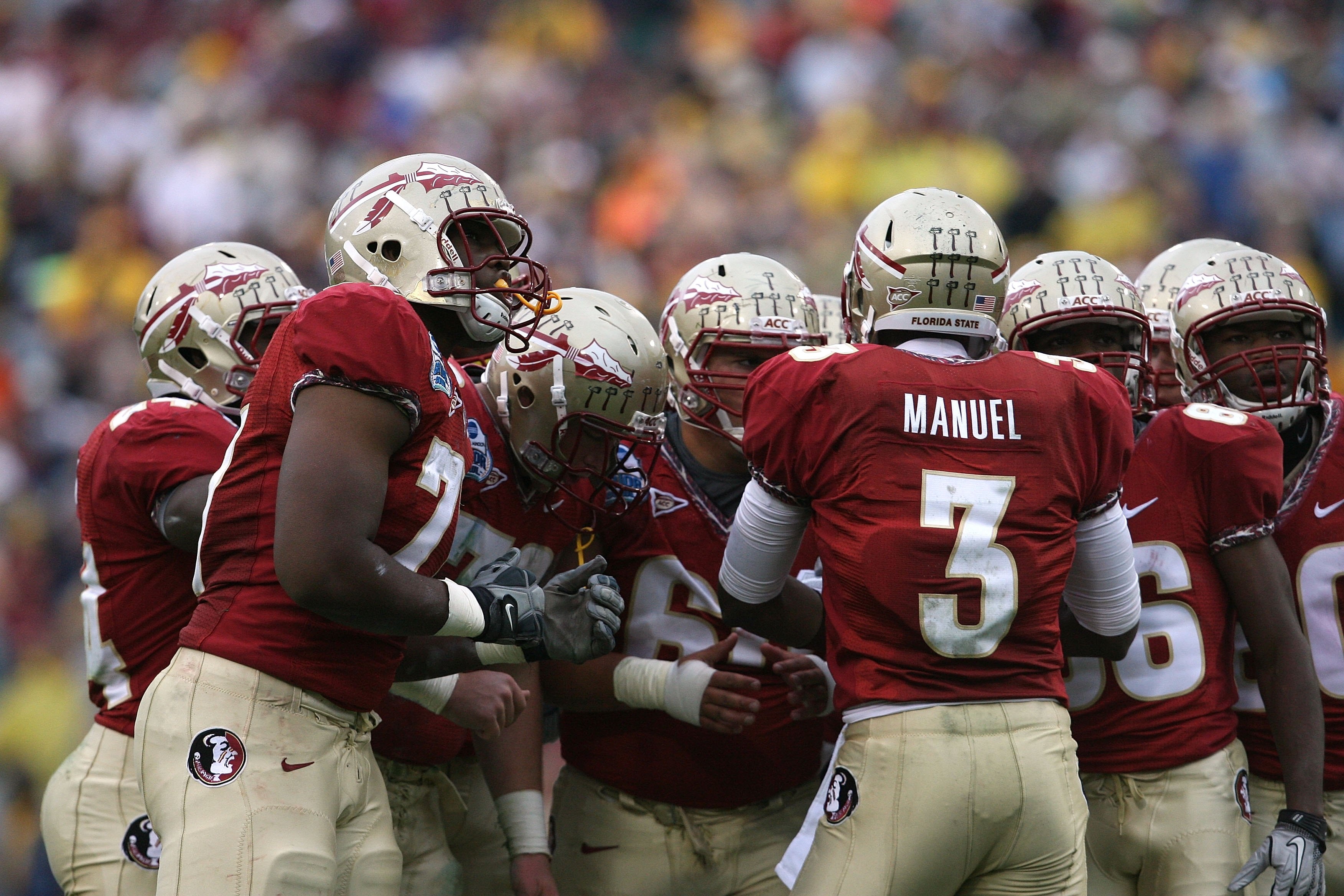 JACKSONVILLE, FL - JANUARY 01: Quarterback E.J. Manuel #3 of the Florida State Seminoles calls out a play in the huddle against the West Virginia Mountaineers during the Konica Minolta Gator Bowl on January 1, 2010 at Jacksonville Municipal Stadium in Ja