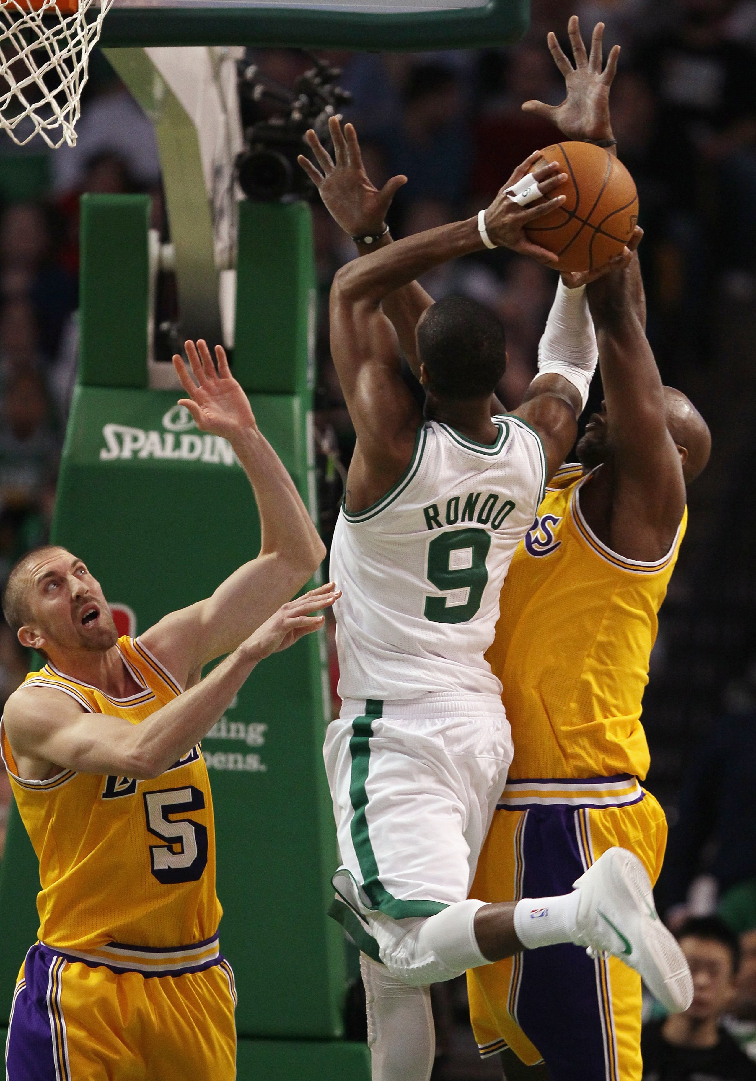 BOSTON, MA - FEBRUARY 10:  Steve Blake #5 and Lamar Odom #7 of the Los Angeles Lakers try to block Rajon Rondo #9 of the Boston Celtics on February 10, 2011 at the TD Garden in Boston, Massachusetts.  The Lakers defeated the Celtics 92-86. NOTE TO USER: U