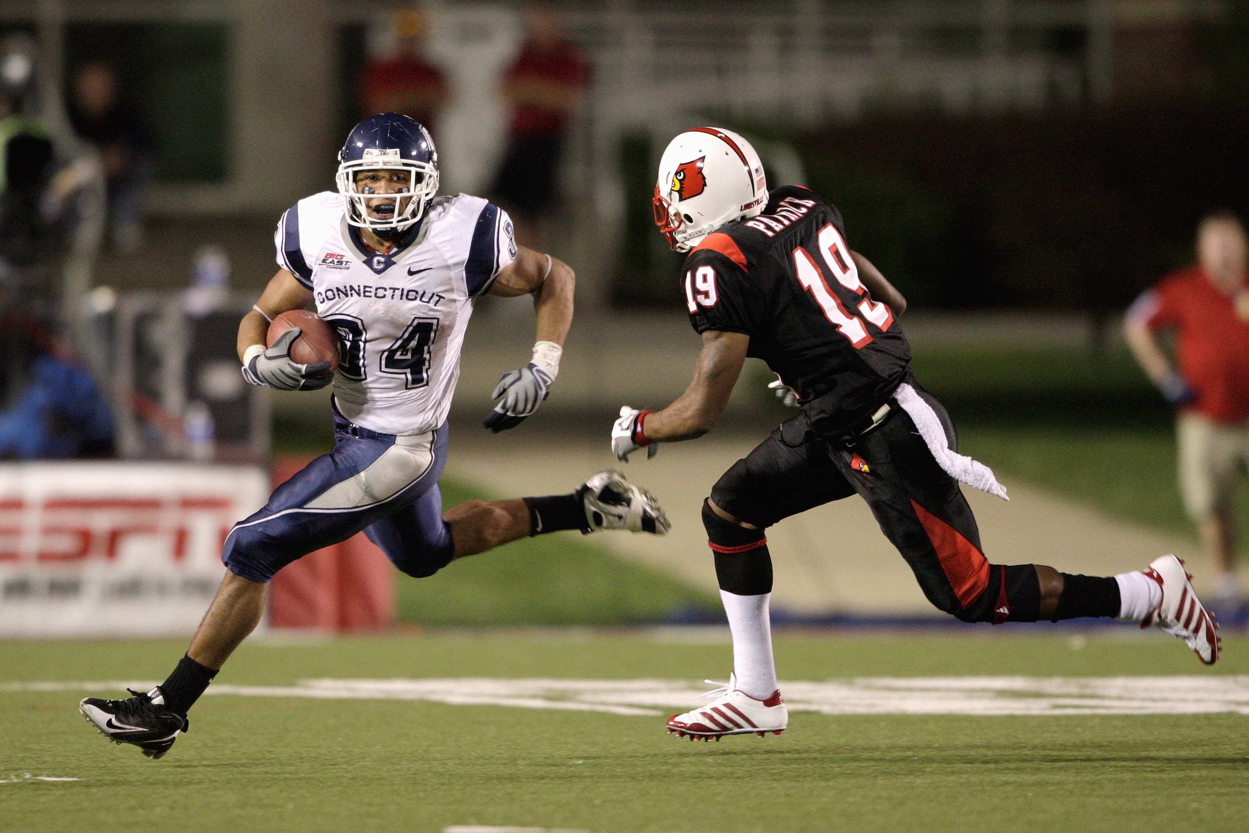 LOUISVILLE, KY - SEPTEMBER 26:  Donald Brown #34 of the Connecticut Huskies carries the ball against Johnny Patrick #19 of the Louisville Cardinals during the Big East game on September 26, 2008 at Papa John's Stadium in Louisville, Kentucky.  (Photo by A