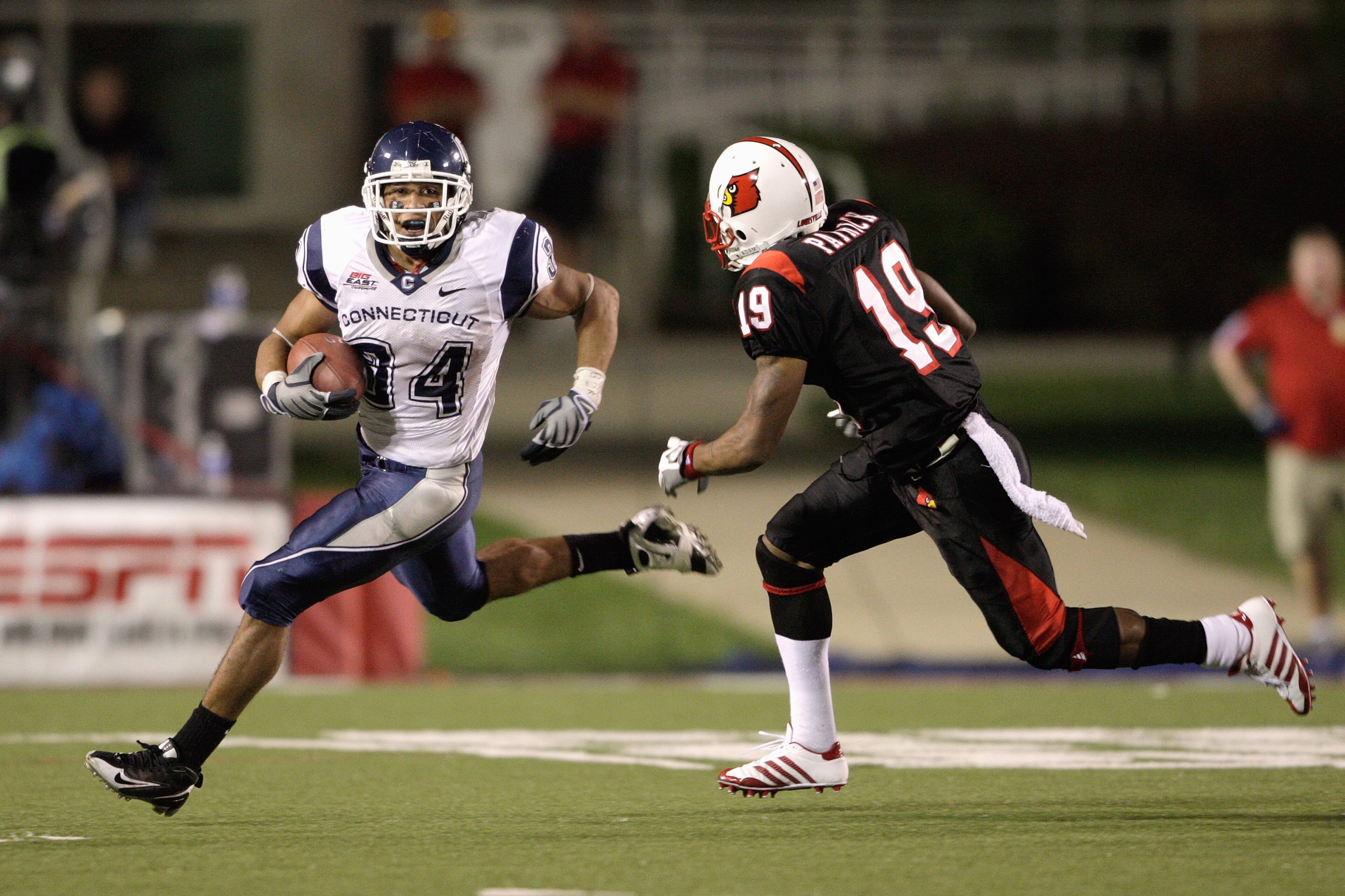 LOUISVILLE, KY - SEPTEMBER 26: Donald Brown #34 of the Connecticut Huskies carries the ball against Johnny Patrick #19 of the Louisville Cardinals during the Big East game on September 26, 2008 at Papa John's Stadium in Louisville, Kentucky. (Photo by A LOUISVILLE, KY - SEPTEMBER 26: Donald Brown #34 of the Connecticut Huskies carries the ball against Johnny Patrick #19 of the Louisville Cardinals during the Big East game on September 26, 2008 at Papa John's Stadium in Louisville, Kentucky. (Photo by A