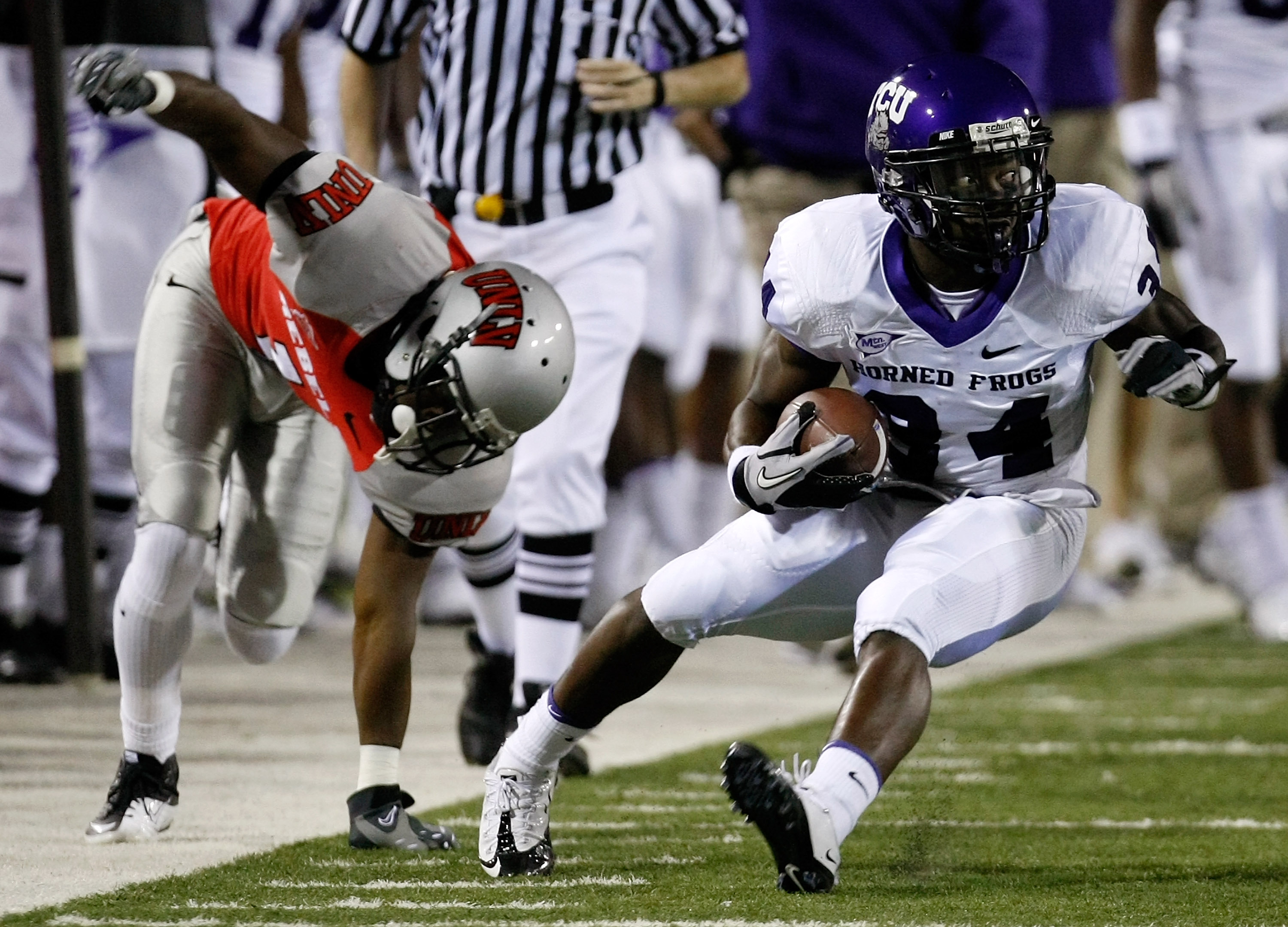 LAS VEGAS - OCTOBER 30:  Ed Wesley #34 of the Texas Christian University Horned Frogs runs for yardage after getting away from Will Chandler #1 of the UNLV Rebels during the first quarter of their game at Sam Boyd Stadium October 30, 2010 in Las Vegas, Ne