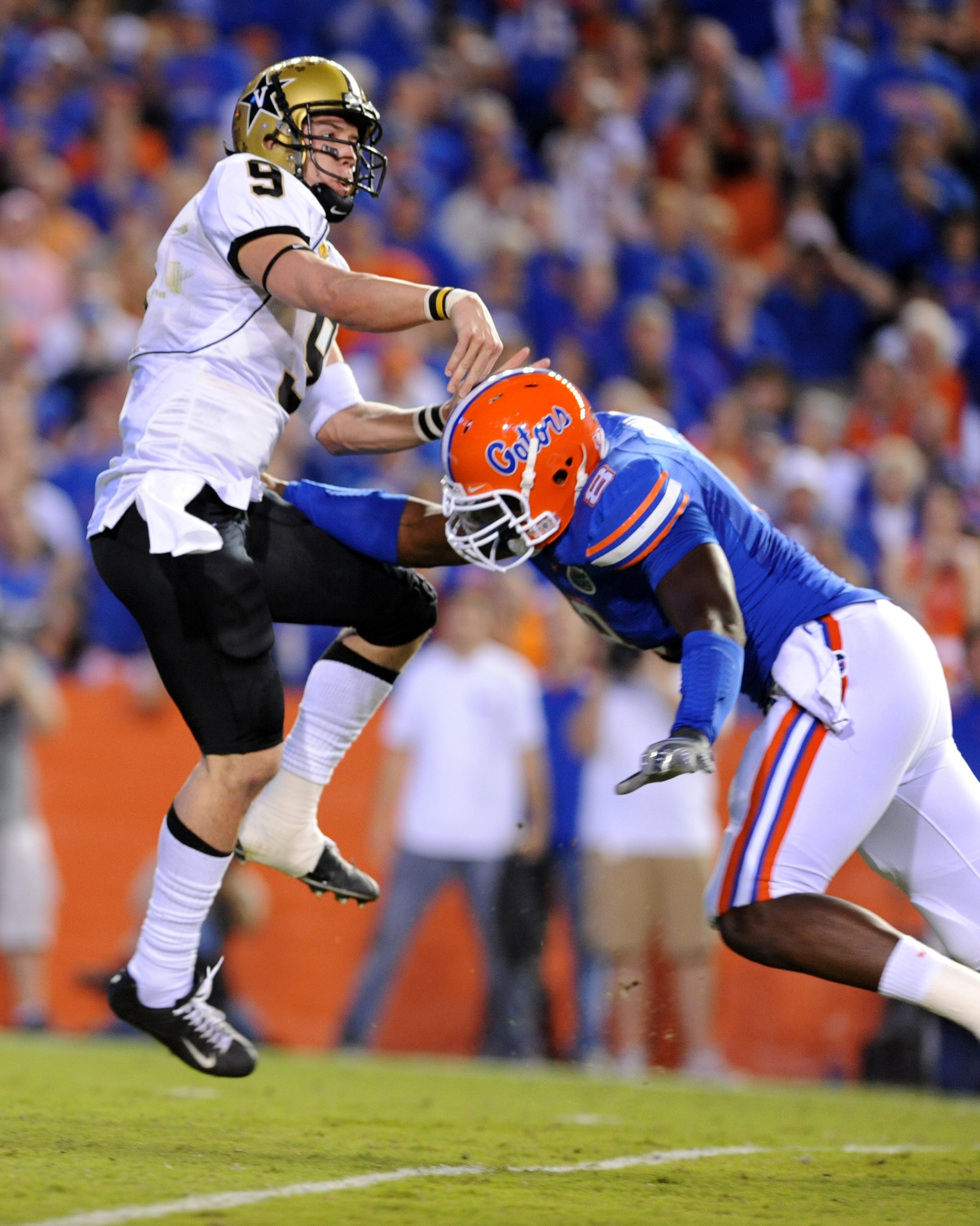 GAINESVILLE, FL - NOVEMBER 7: Defensive end Carlos Dunlap #8  of the Florida Gators rushes quarterback Mackenzi Adams #9 the Vanderbilt Commodores  on November 7, 2009 at Ben Hill Griffin Stadium in Gainesville, Florida.  (Photo by Al Messerschmidt/Getty 