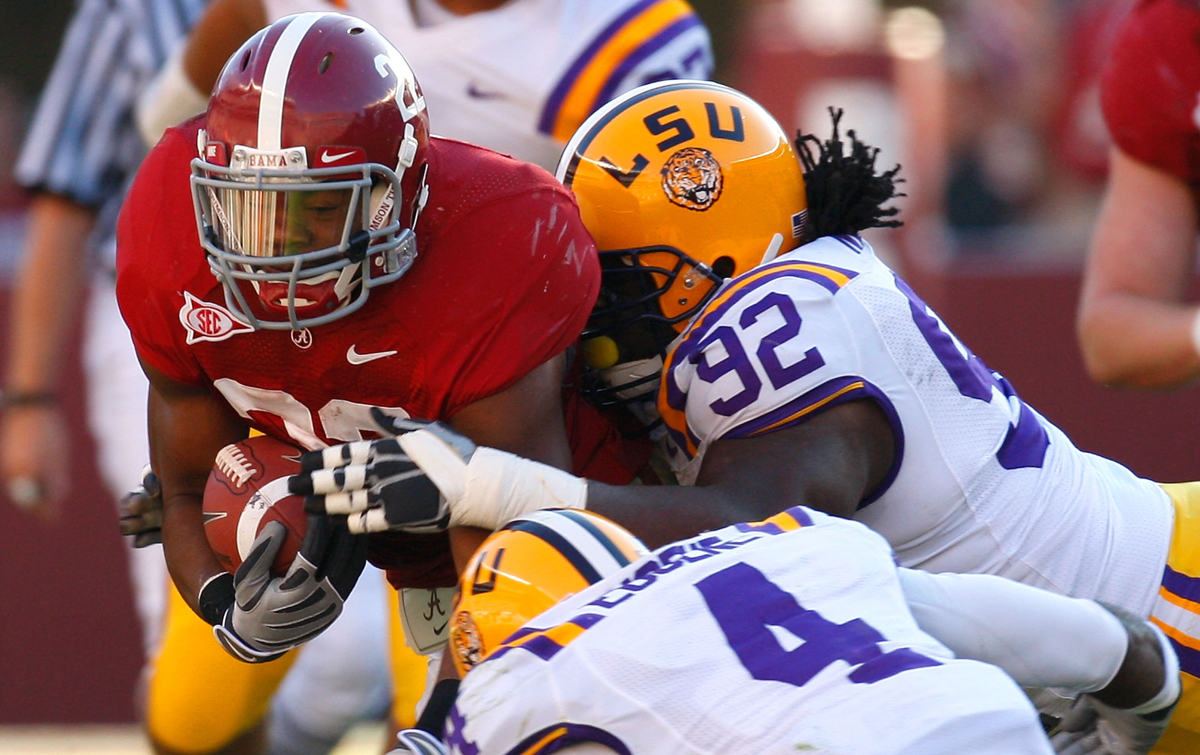 TUSCALOOSA, AL - NOVEMBER 07: Mark Ingram #22 of the Alabama Crimson Tide is tackled by Drake Nevis #92 and Jai Eugene #4 of the Louisiana State University Tigers at Bryant-Denny Stadium on November 7, 2009 in Tuscaloosa, Alabama. (Photo by Kevin C. Cox TUSCALOOSA, AL - NOVEMBER 07: Mark Ingram #22 of the Alabama Crimson Tide is tackled by Drake Nevis #92 and Jai Eugene #4 of the Louisiana State University Tigers at Bryant-Denny Stadium on November 7, 2009 in Tuscaloosa, Alabama. (Photo by Kevin C. Cox