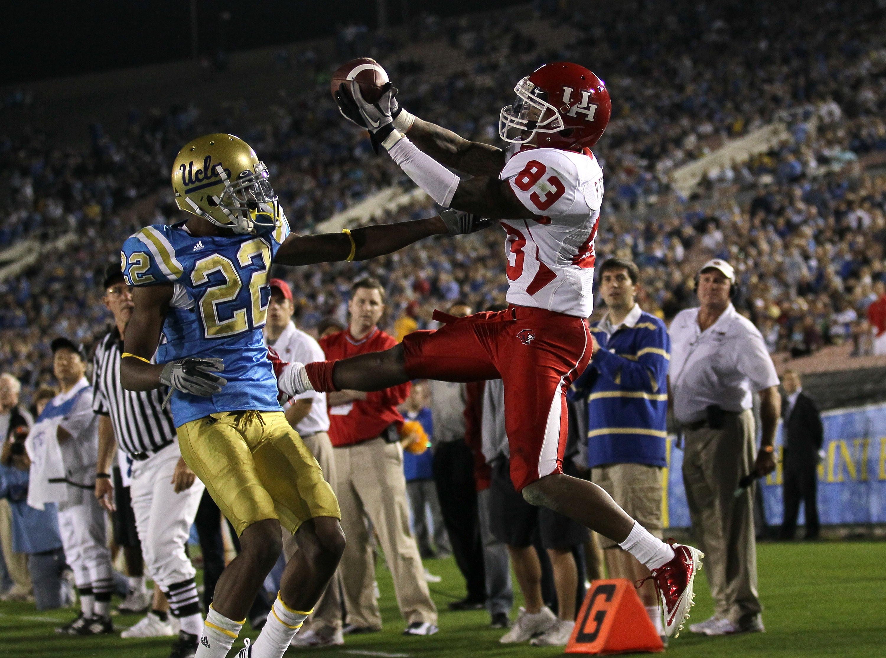 PASADENA, CA - SEPTEMBER 18:  Wide receiver Patrick Edwards #83 of the Houston Cougars goes up for the balll against cornerback Sheldon Price #22 of the UCLA Bruins at the Rose Bowl on September 18, 2010 in Pasadena, California.  UCLA won 31-13.  (Photo b