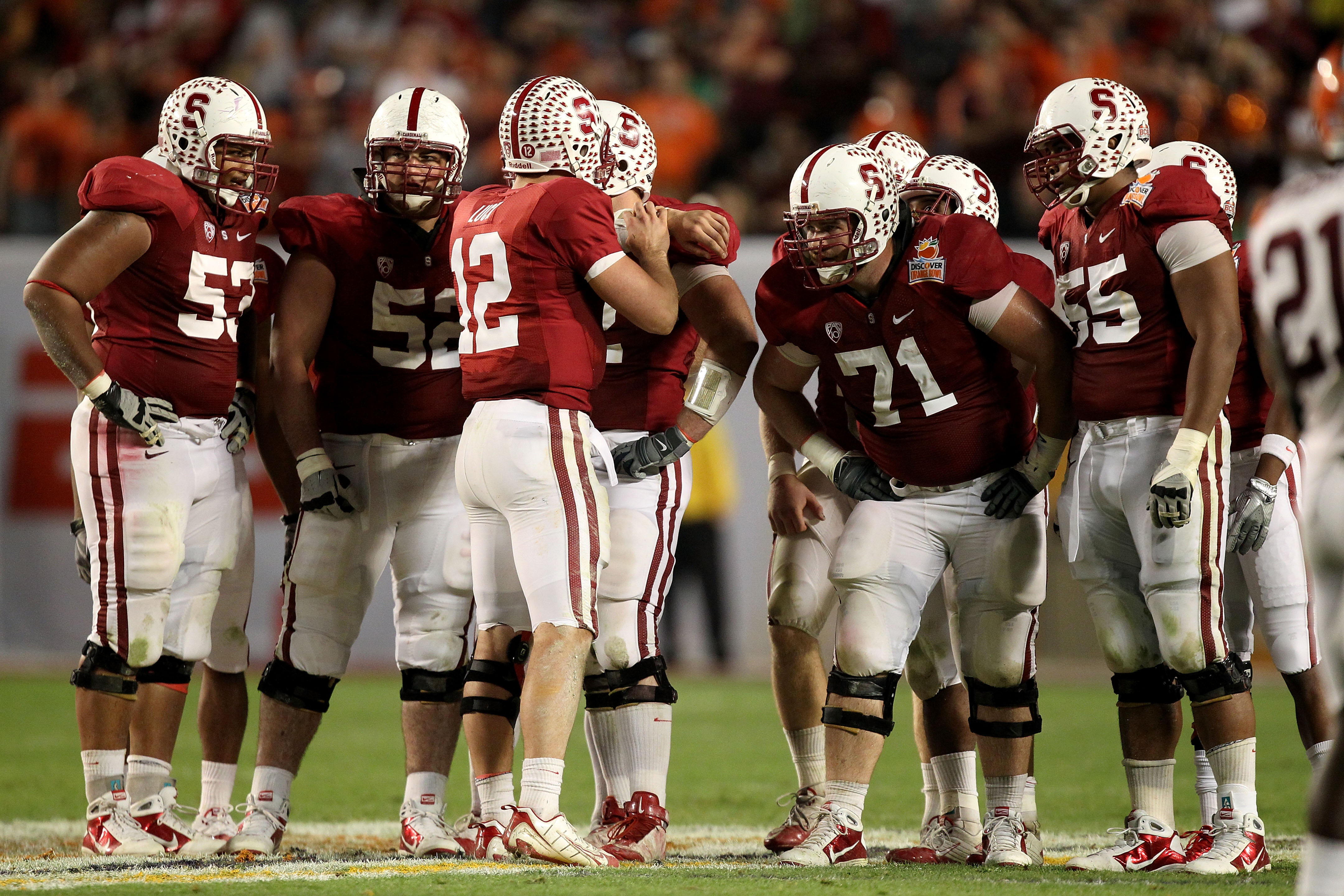 MIAMI, FL - JANUARY 03:  Quarterback Andrew Luck #12 of the Stanford Cardinal calls a play in the huddle as Derek Hall #53, David DeCastro #52, Andrew Phillips #71 and Jonathan Martin #55 listen to the call against the Virginai Tech Hokies during the 2011