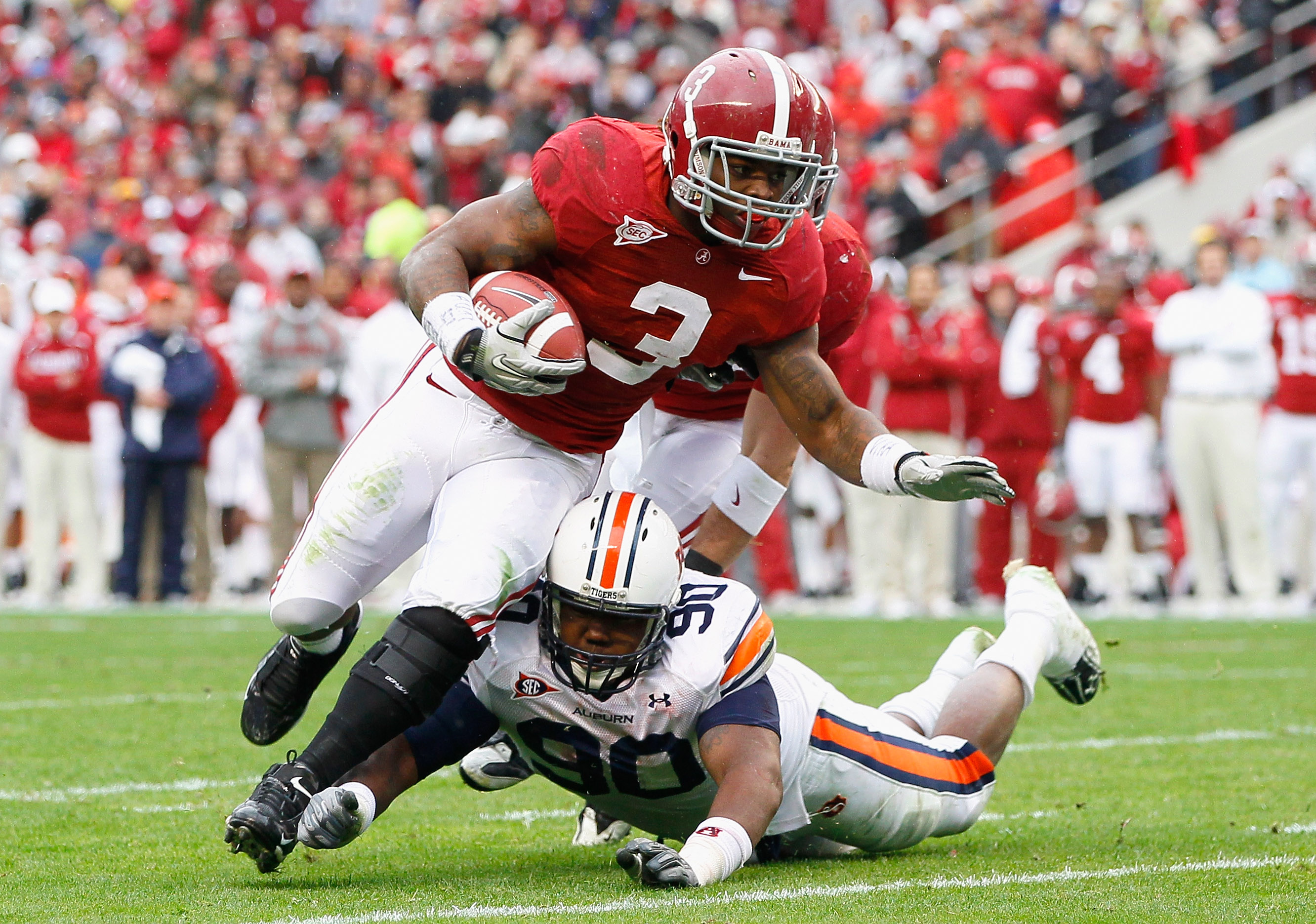 TUSCALOOSA, AL - NOVEMBER 26:  Trent Richardson #3 of the Alabama Crimson Tide is tackled by Nick Fairly #90 of the Auburn Tigers at Bryant-Denny Stadium on November 26, 2010 in Tuscaloosa, Alabama.  (Photo by Kevin C. Cox/Getty Images)
