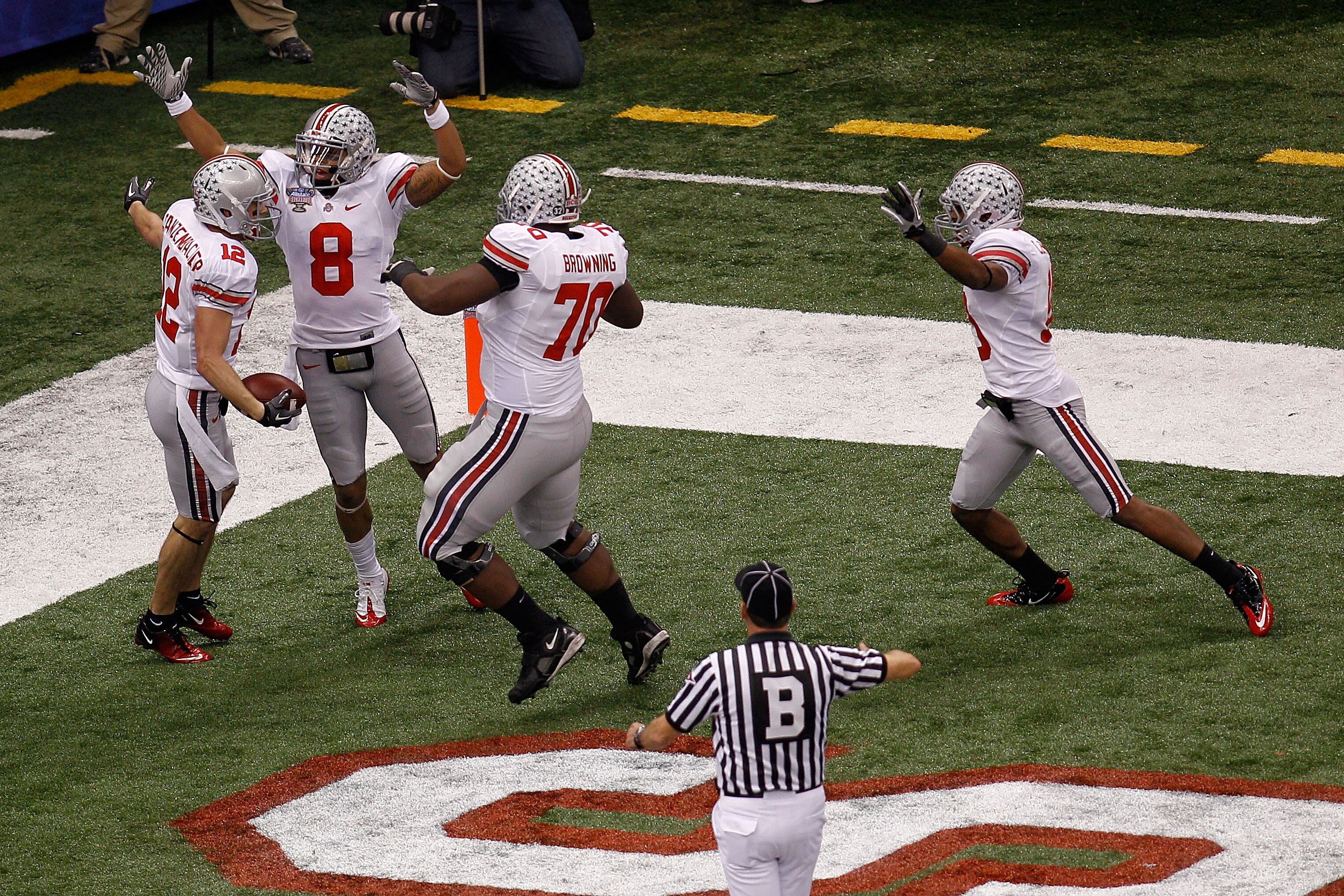 NEW ORLEANS, LA - JANUARY 04:  DeVier Posey #8, Bryant Browning #70 and Dane Sanzenbacher #12 of the Ohio State Buckeyes celebrate Sanzenbachers touchdown on a fumble recovery in the first quarter against the Arkansas Razorbacks during the Allstate Sugar 