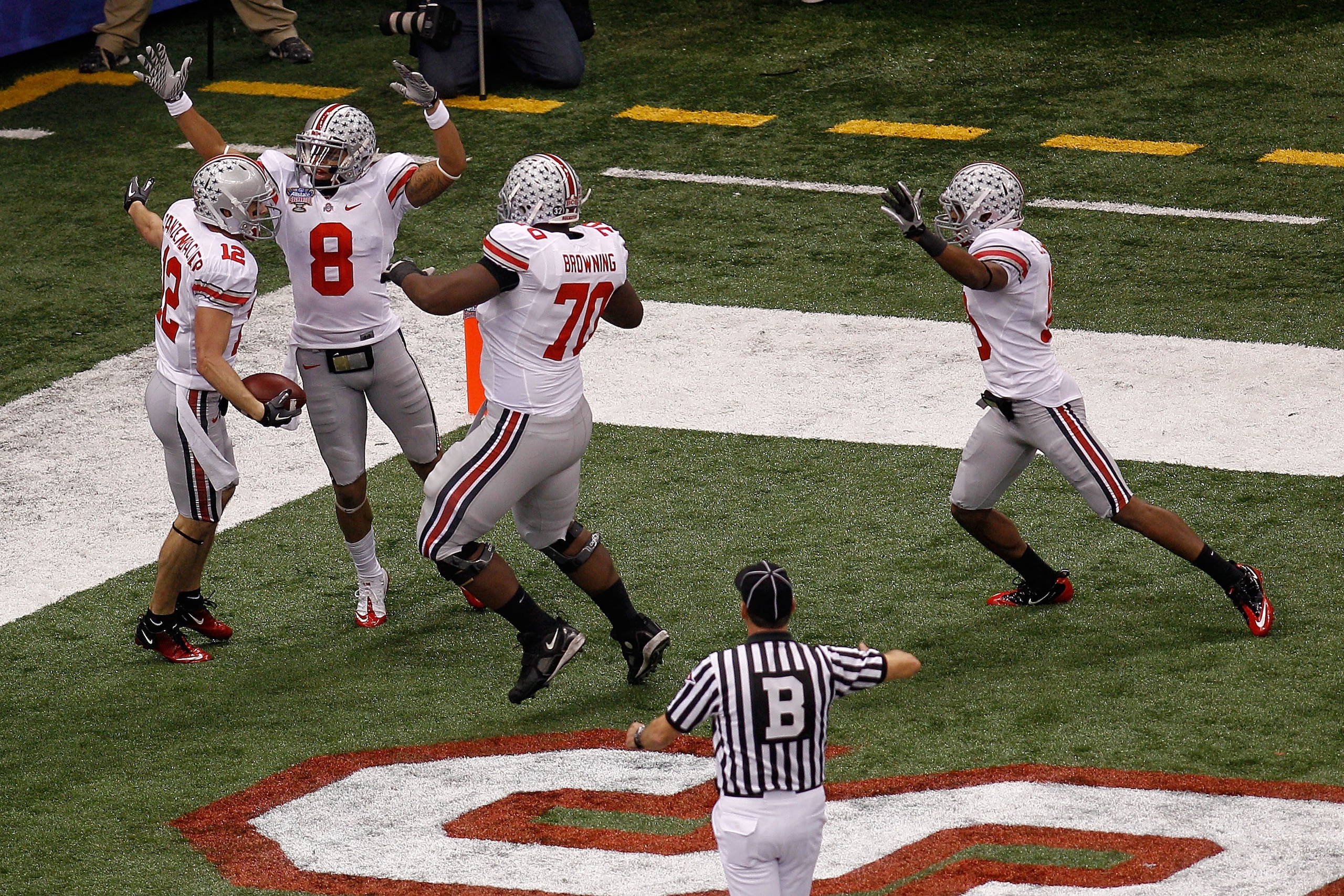 NEW ORLEANS, LA - JANUARY 04:  DeVier Posey #8, Bryant Browning #70 and Dane Sanzenbacher #12 of the Ohio State Buckeyes celebrate Sanzenbachers touchdown on a fumble recovery in the first quarter against the Arkansas Razorbacks during the Allstate Sugar 
