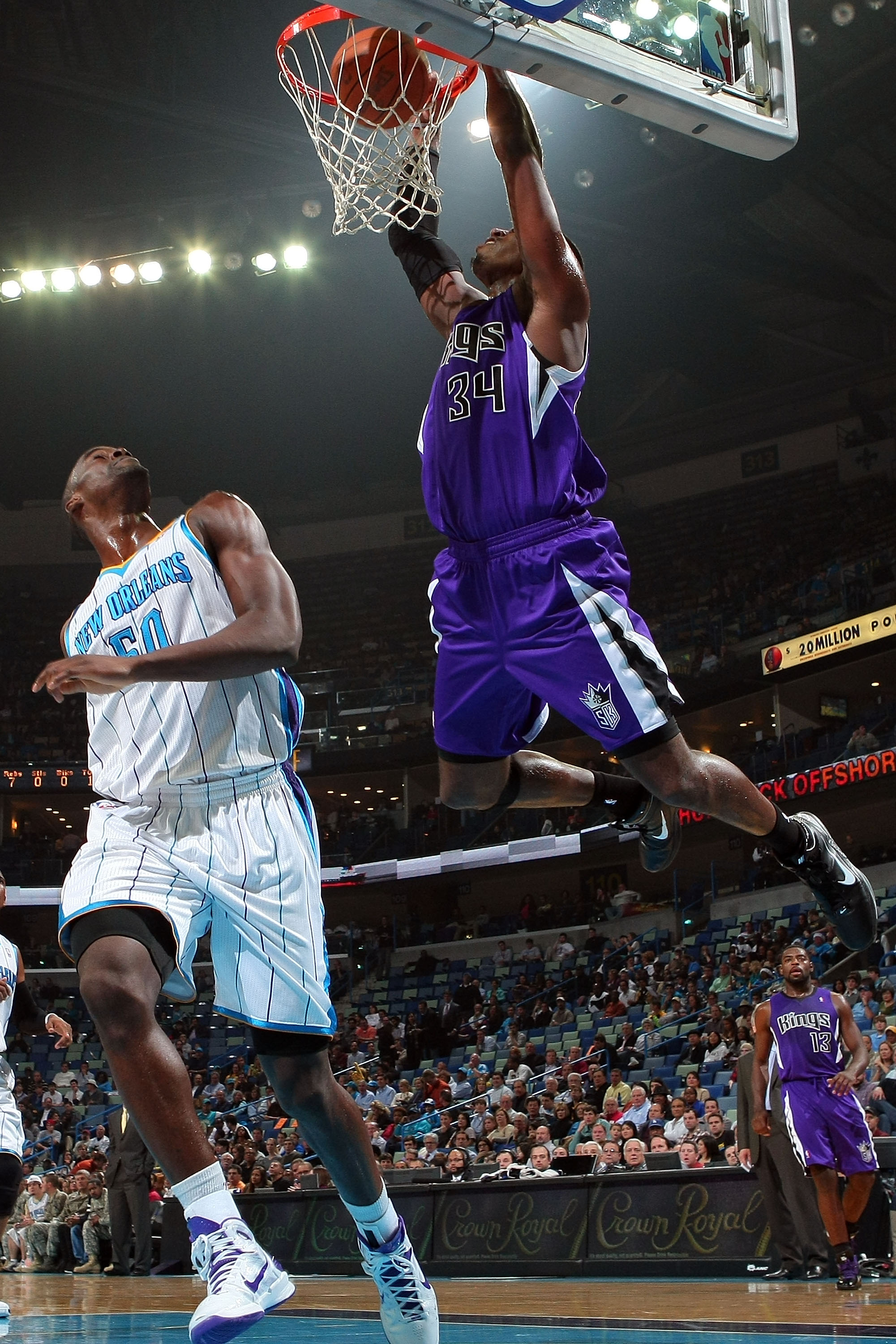 NEW ORLEANS, LA - DECEMBER 15:  Jason Thompson #34 of the Sacramento Kings dunks the ball over Emeka Okafor #50 of the New Orleans Hornets  at the New Orleans Arena on December 15, 2010 in New Orleans, Louisiana.  NOTE TO USER: User expressly acknowledges