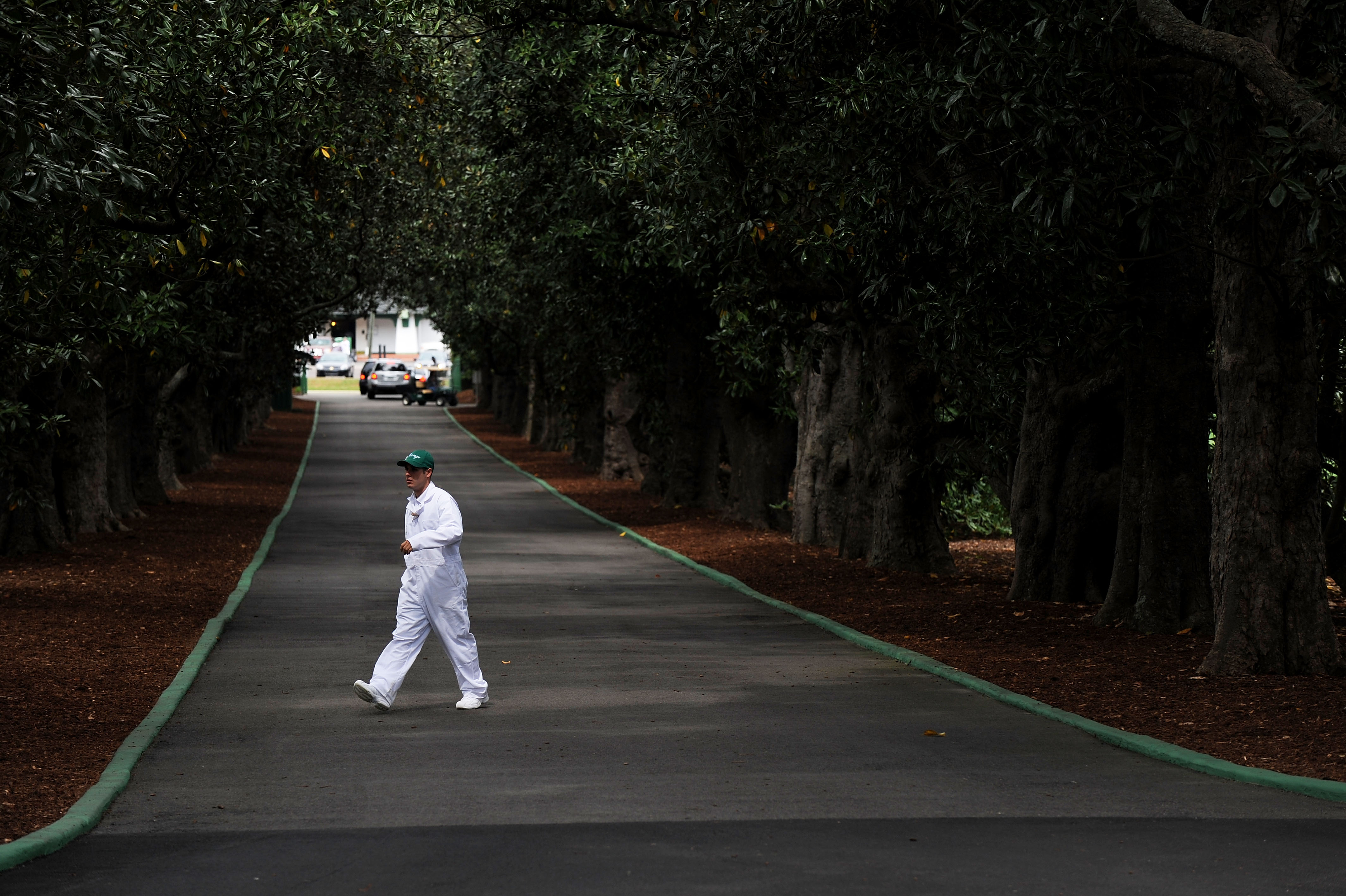AUGUSTA, GA - APRIL 05:  A caddie crosses Magnolia Lane prior to the 2009 Masters Tournament at Augusta National Golf Club on April 5, 2009 in Augusta, Georgia.  (Photo by Harry How/Getty Images)