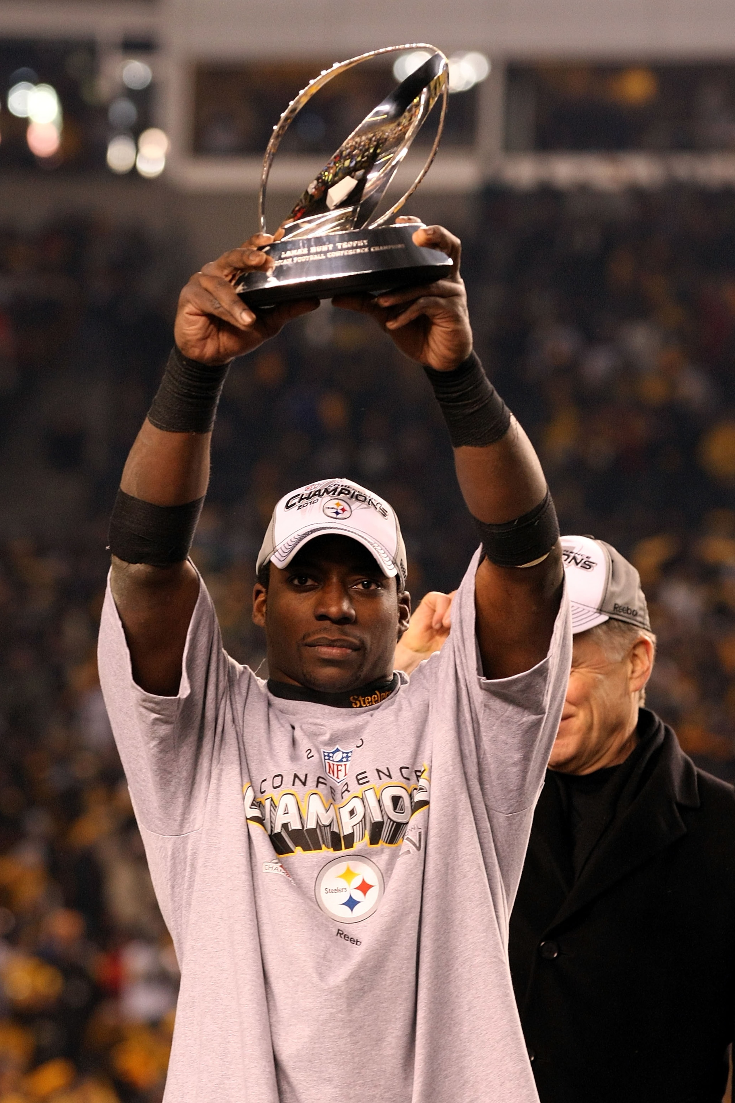 PITTSBURGH, PA - JANUARY 23:  Rashard Mendenhall #34 of the Pittsburgh Steelers holds up the Lamar Hunt trophy after the Steelers defeated the New York Jets 24 to 19 in the 2011 AFC Championship game at Heinz Field on January 23, 2011 in Pittsburgh, Penns