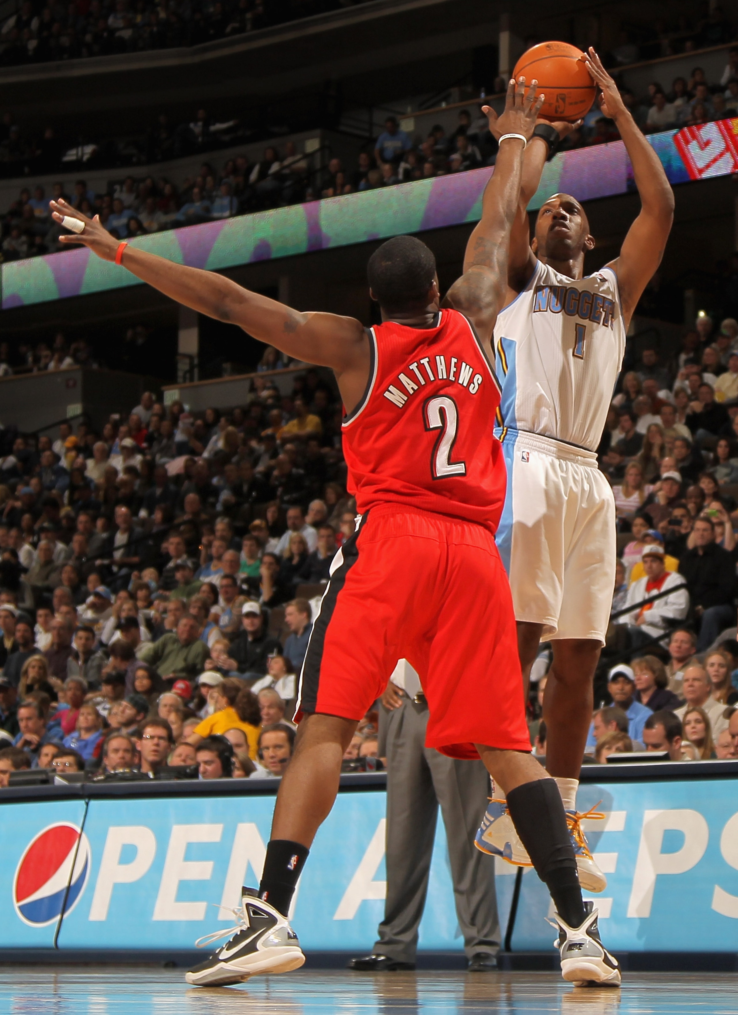 DENVER - DECEMBER 28:  Chauncey Billups #1 of the Denver Nuggets takes a shot over Wesley Matthews #2 of the Portland Trail Blazers at Pepsi Center on December 28, 2010 in Denver, Colorado. The Nuggets defeated the Blazers 95-77. NOTE TO USER: User expres
