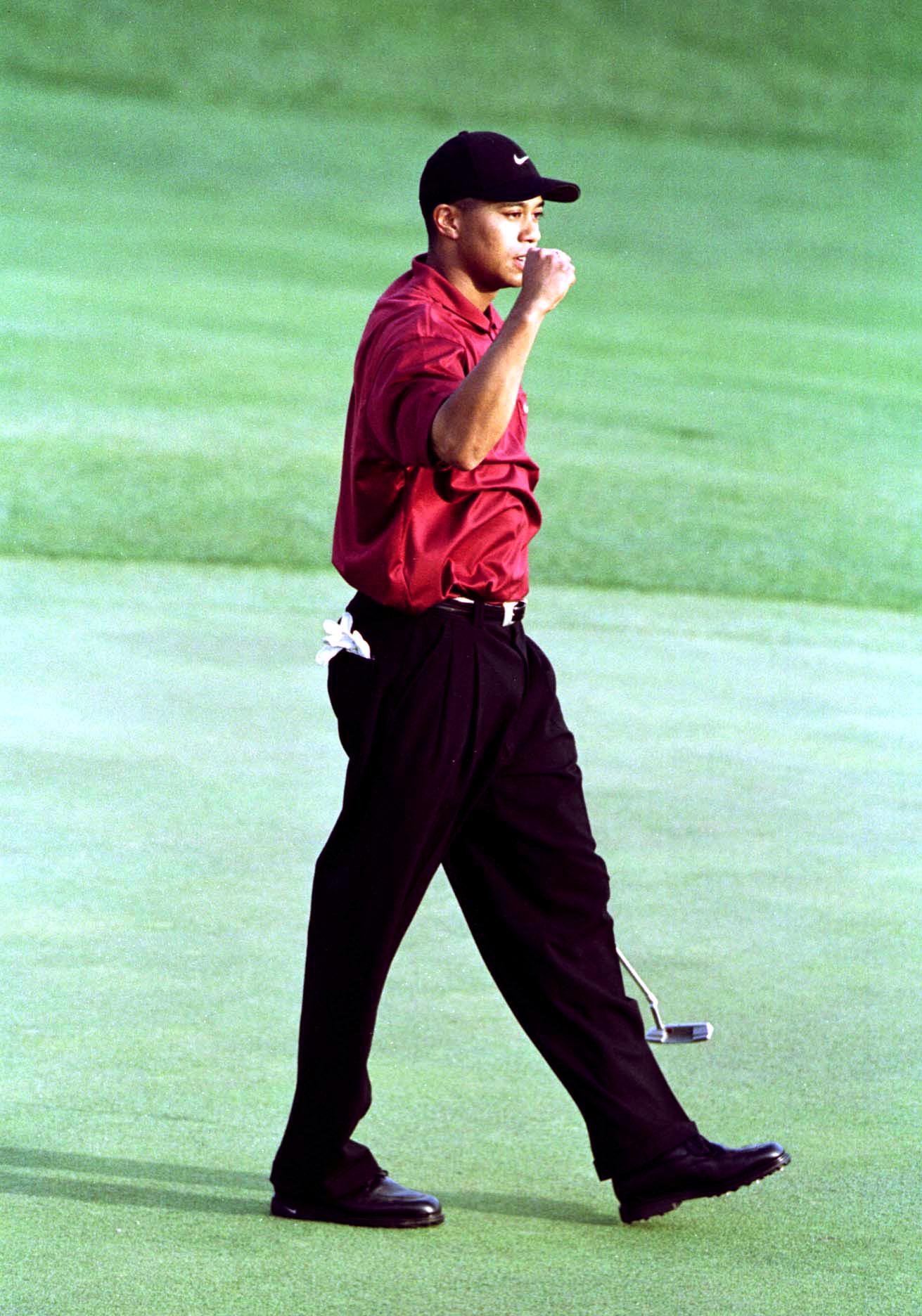 8 Apr 2001:  Tiger Woods of the USA celebrates after winning the Masterson the 18th green during the final day of the 2001 Masters at the Augusta National Golf Club, Augusta, GA, USA. Mandatory Credit: Harry How/ALLSPORT