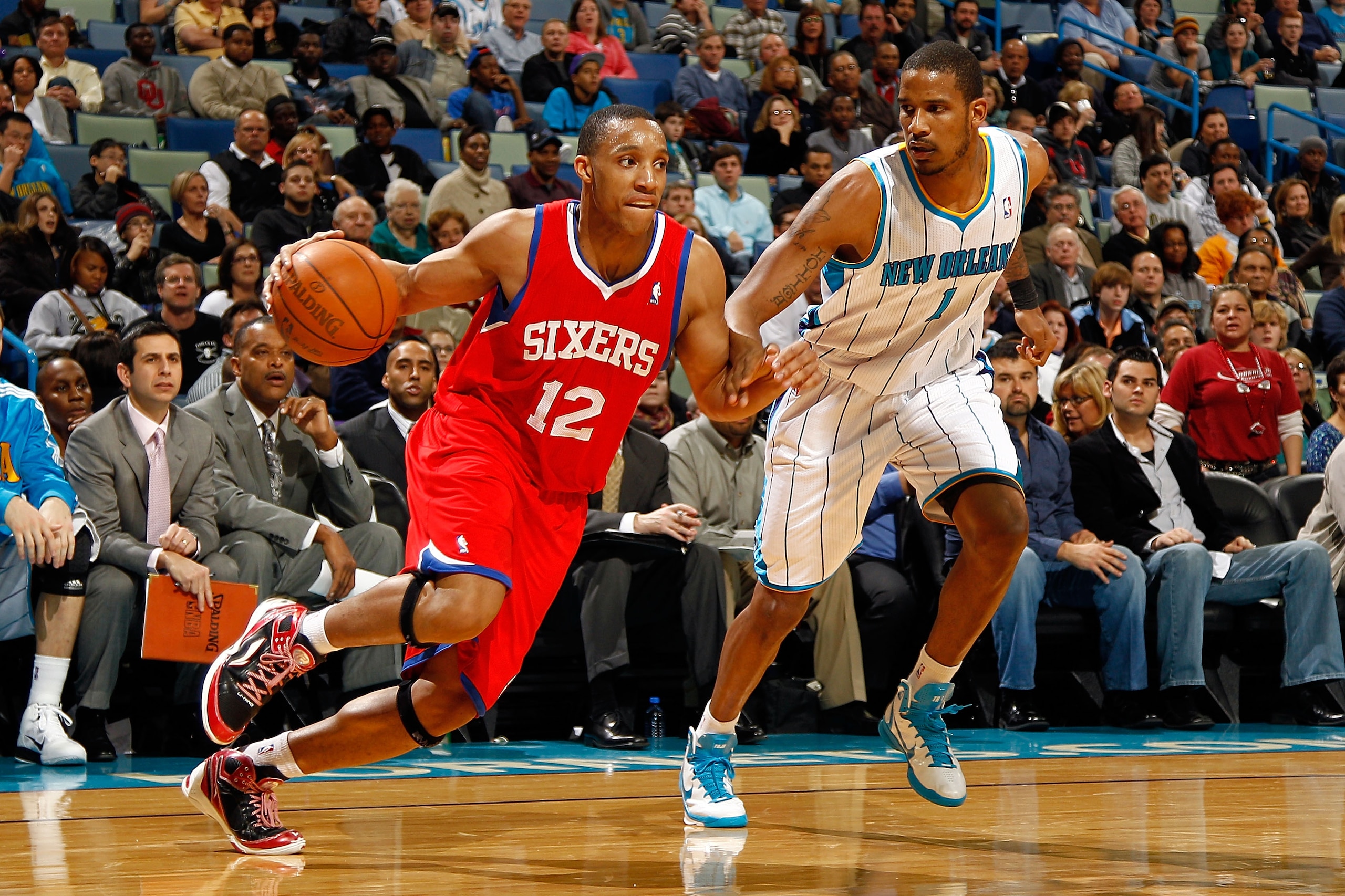 NEW ORLEANS, LA - JANUARY 03:  Evan Turner #12 of the Philadelphia 76ers drives on Trevor Ariza #1 of the New Orleans Hornets in the second half at New Orleans Arena on January 3, 2011 in New Orleans, Louisiana. NOTE TO USER: User expressly acknowledges a