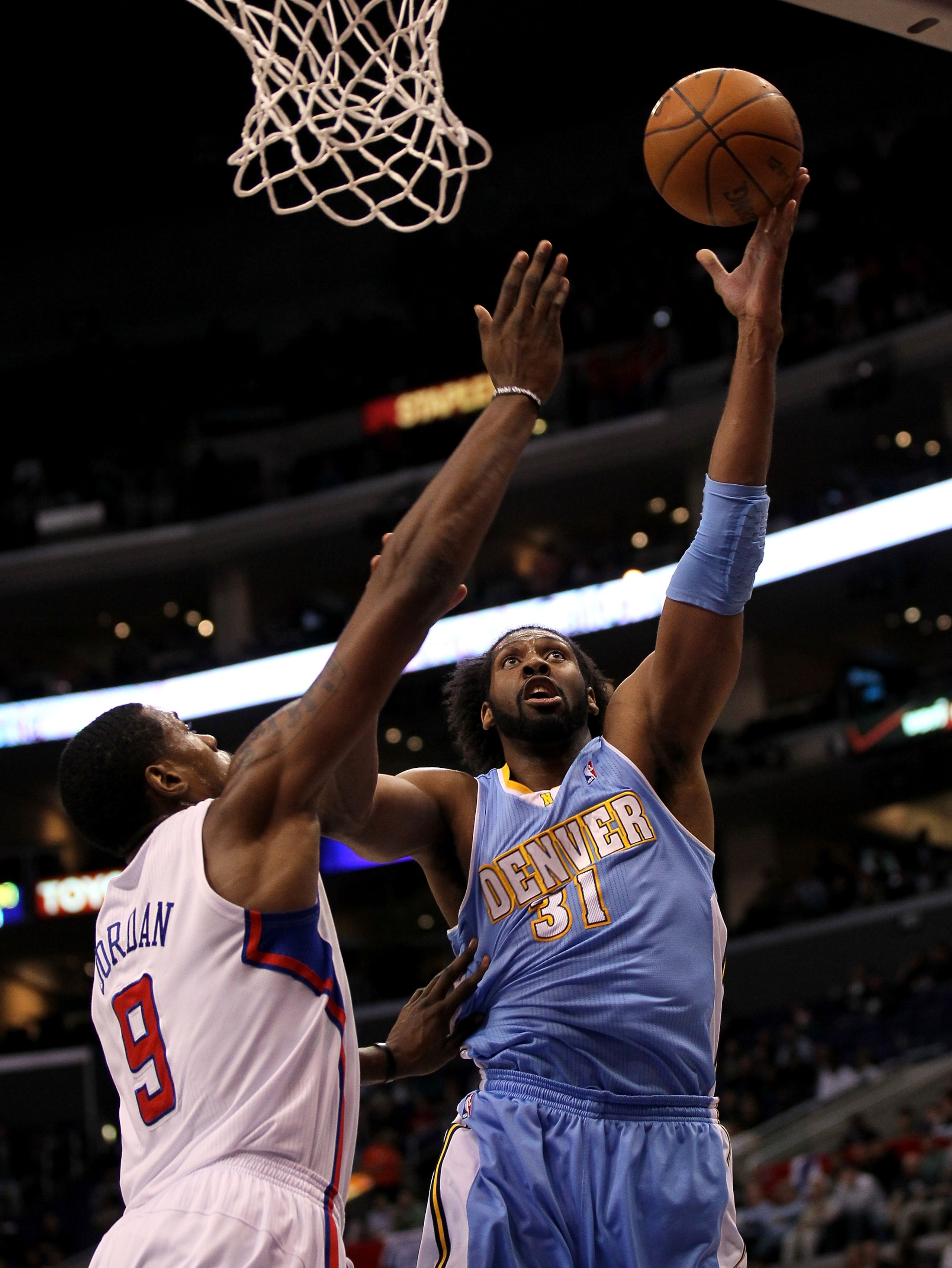LOS ANGELES, CA - JANUARY 5: Nene #31 of the Denver Nuggets shoots over DeAndre Jordan #9 of the Los Angeles Clippers at Staples Center on January 5, 2011 in Los Angeles, California. NOTE TO USER: User expressly acknowledges and agrees that, by downloa LOS ANGELES, CA - JANUARY 5: Nene #31 of the Denver Nuggets shoots over DeAndre Jordan #9 of the Los Angeles Clippers at Staples Center on January 5, 2011 in Los Angeles, California. NOTE TO USER: User expressly acknowledges and agrees that, by downloa