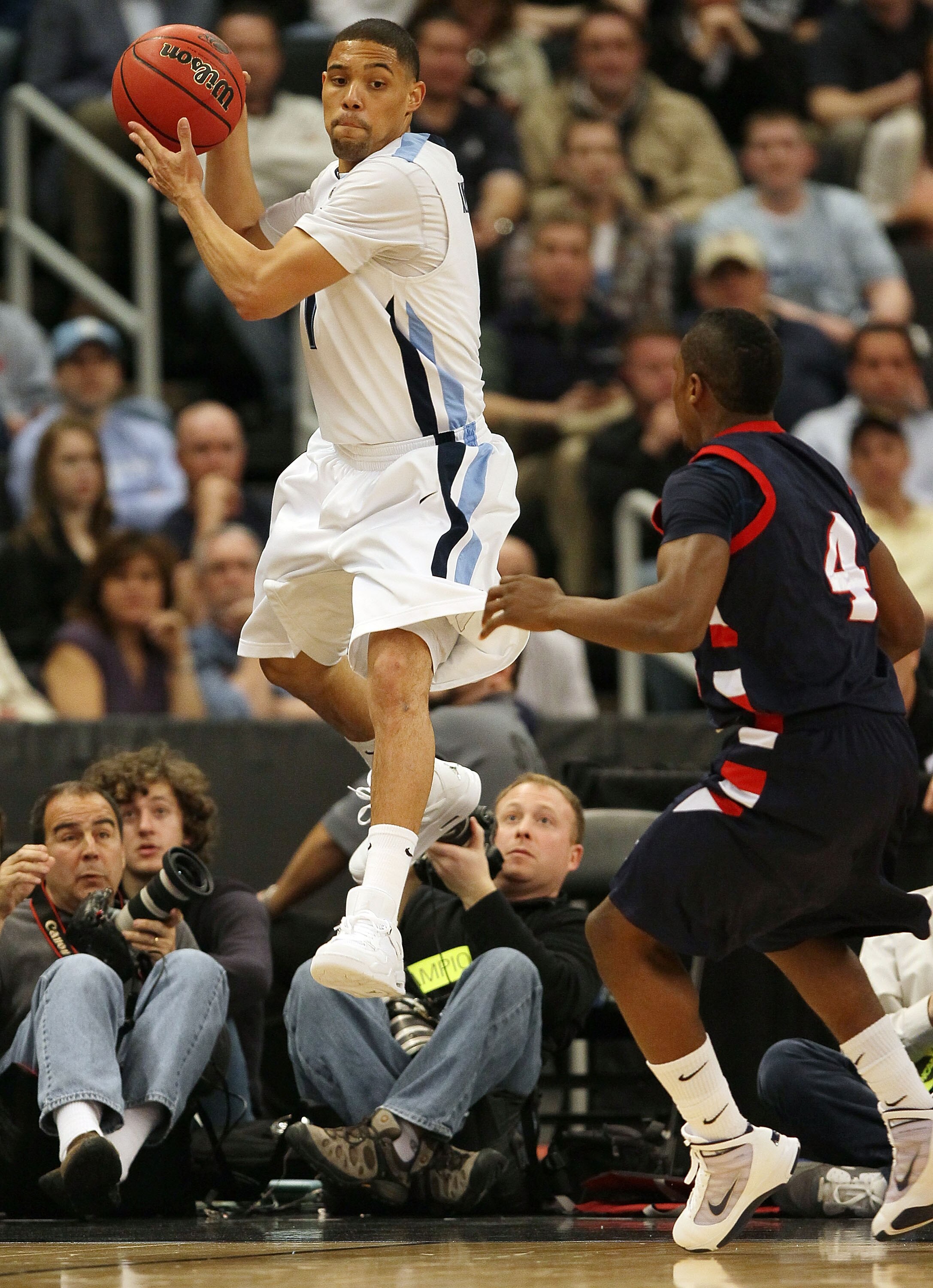 PROVIDENCE, RI - MARCH 18:  Scottie Reynolds #1  of the Villanova Wildcats passes the ball as Karon Abraham #4 of the Robert Morris Colonials defends during the first round of the 2010 NCAA men's basketball tournament on March 18, 2010 at the Dunkin Donut