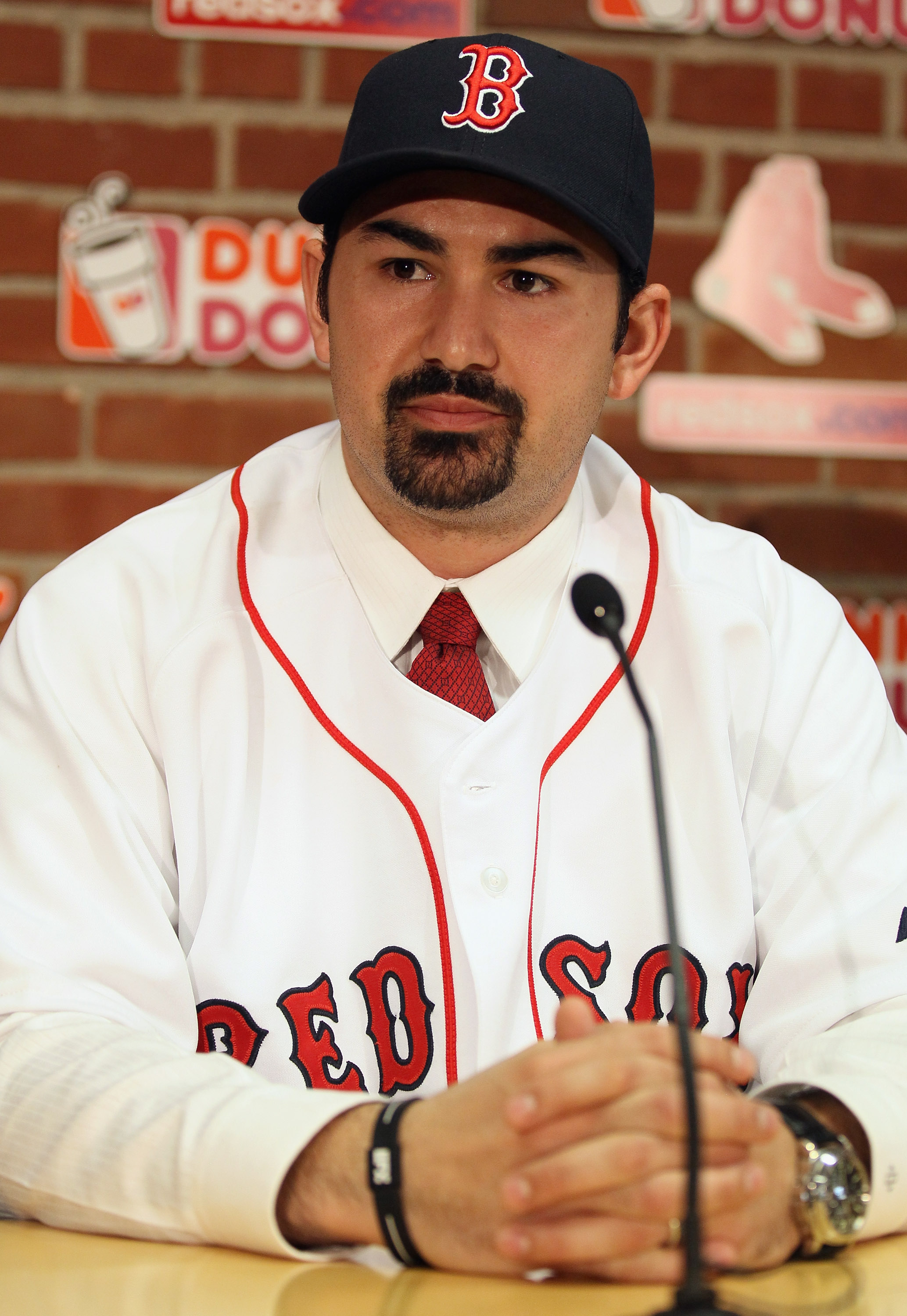 BOSTON, MA - DECEMBER 06:  Adrian Gonzalez answers questions during a press conference to announce his signing with the Boston Red Sox on December 6,  2010 at Fenway Park in Boston, Massachusetts.  (Photo by Elsa/Getty Images)