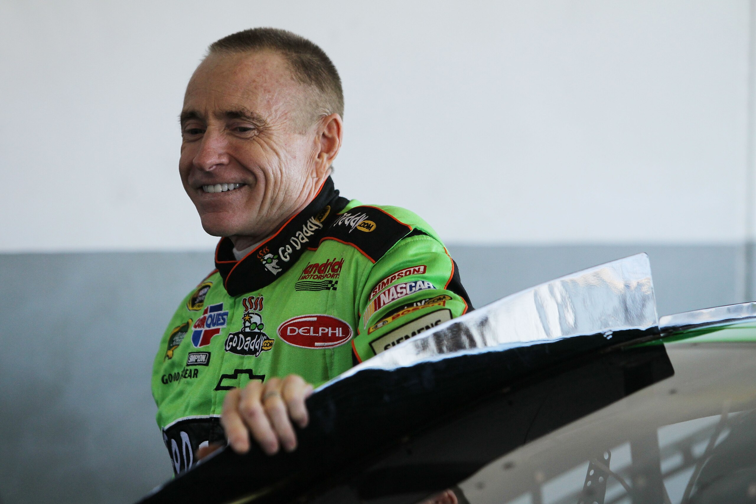 DAYTONA BEACH, FL - FEBRUARY 11:  Mark Martin, driver of the #5 GoDaddy.com Chevrolet, stands in the garage area during practice for the NASCAR Budweiser Shootout at Daytona International Speedway on February 11, 2011 in Daytona Beach, Florida.  (Photo by