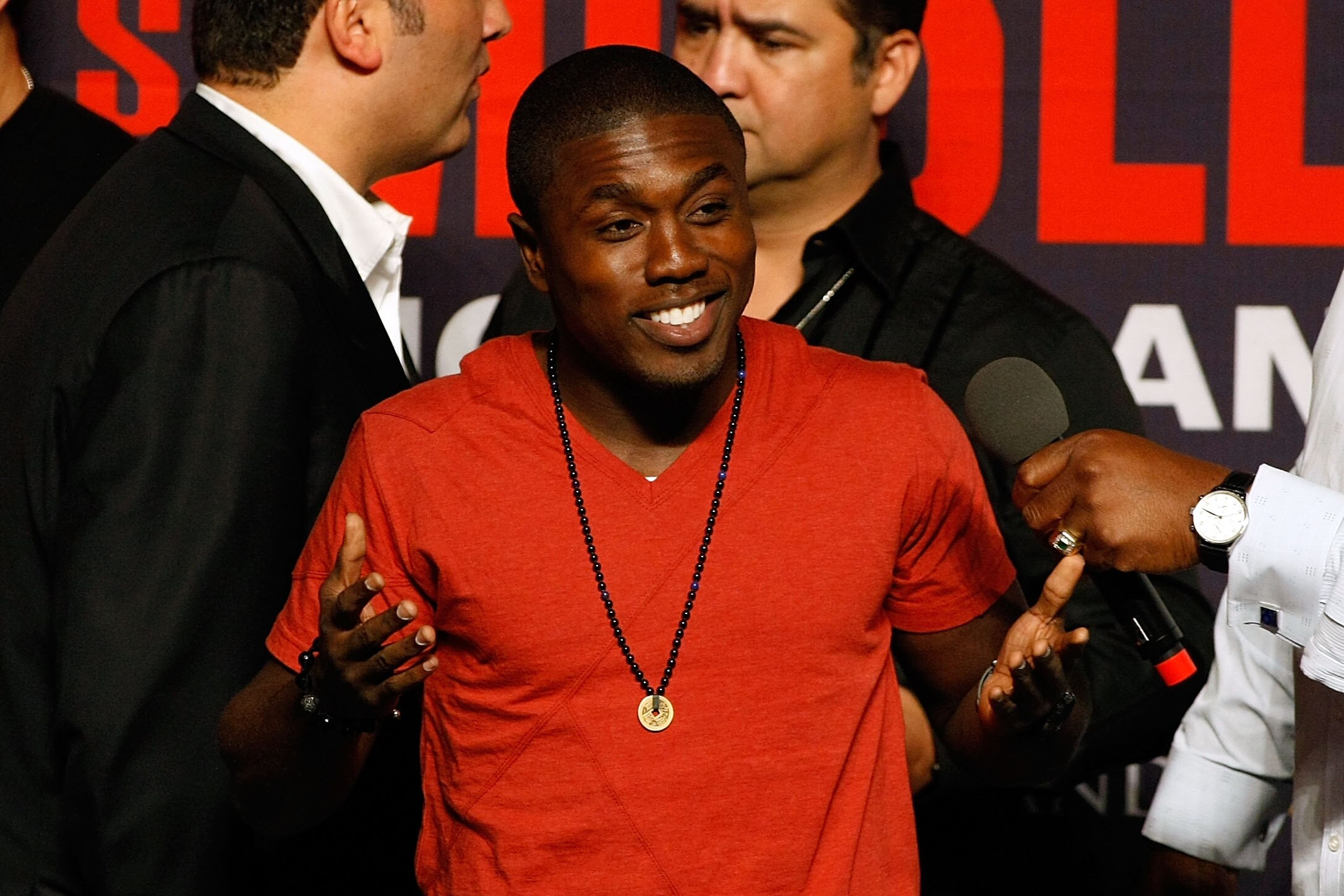 LAS VEGAS - APRIL 30:  Boxer Andre Berto reacts to the crowd from the stage before the start of the Floyd Mayweather Jr. and Shane Mosley weigh-in at the MGM Grand Garden Arena on April 30, 2010 in Las Vegas, Nevada. Mayweather and Mosley will meet in a 1