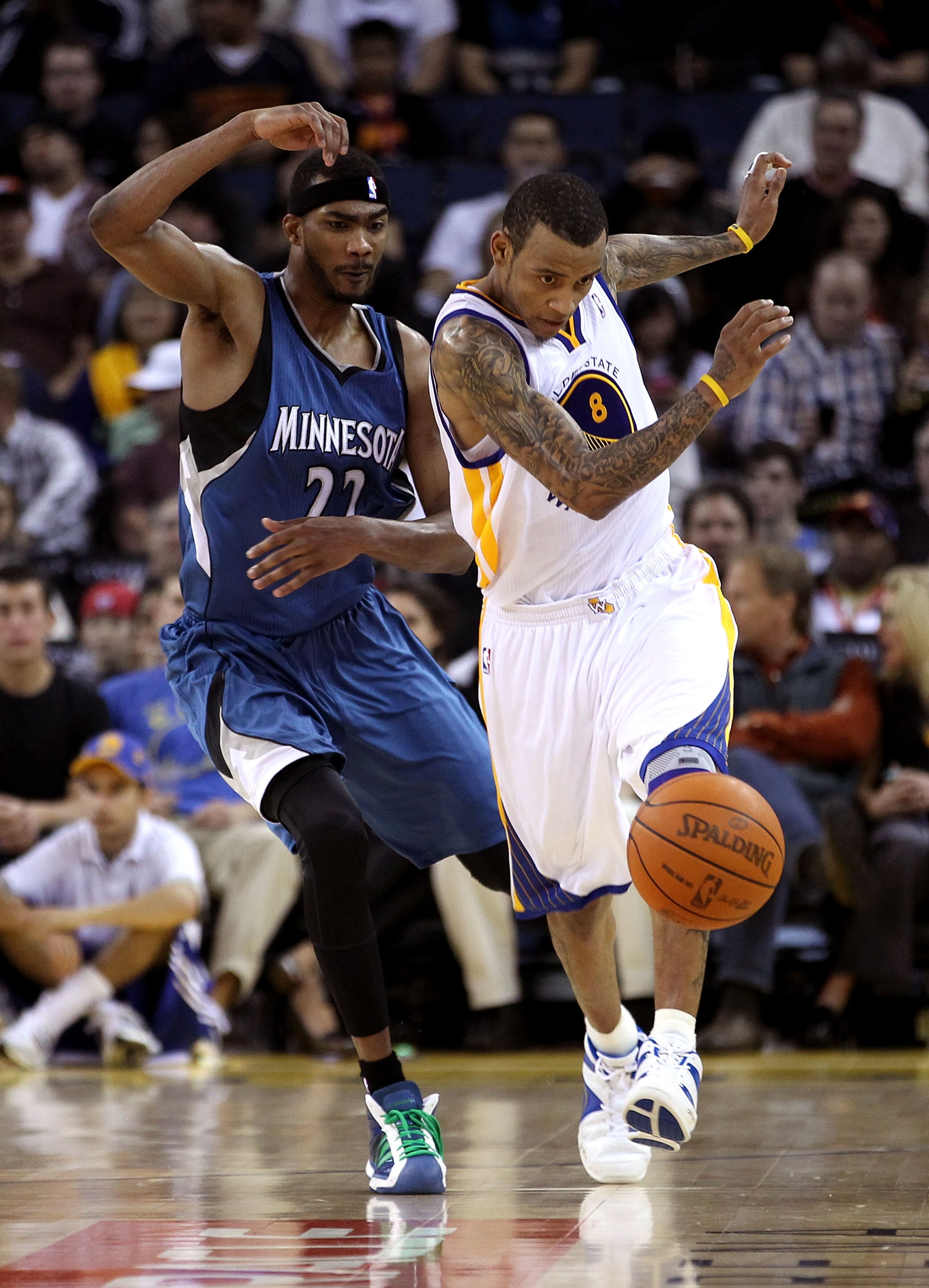 OAKLAND, CA - DECEMBER 14:  Monta Ellis #8 of the Golden State Warriors and Corey Brewer #22 of the Minnesota Timberwolves go for the ball at Oracle Arena on December 14, 2010 in Oakland, California.  NOTE TO USER: User expressly acknowledges and agrees t