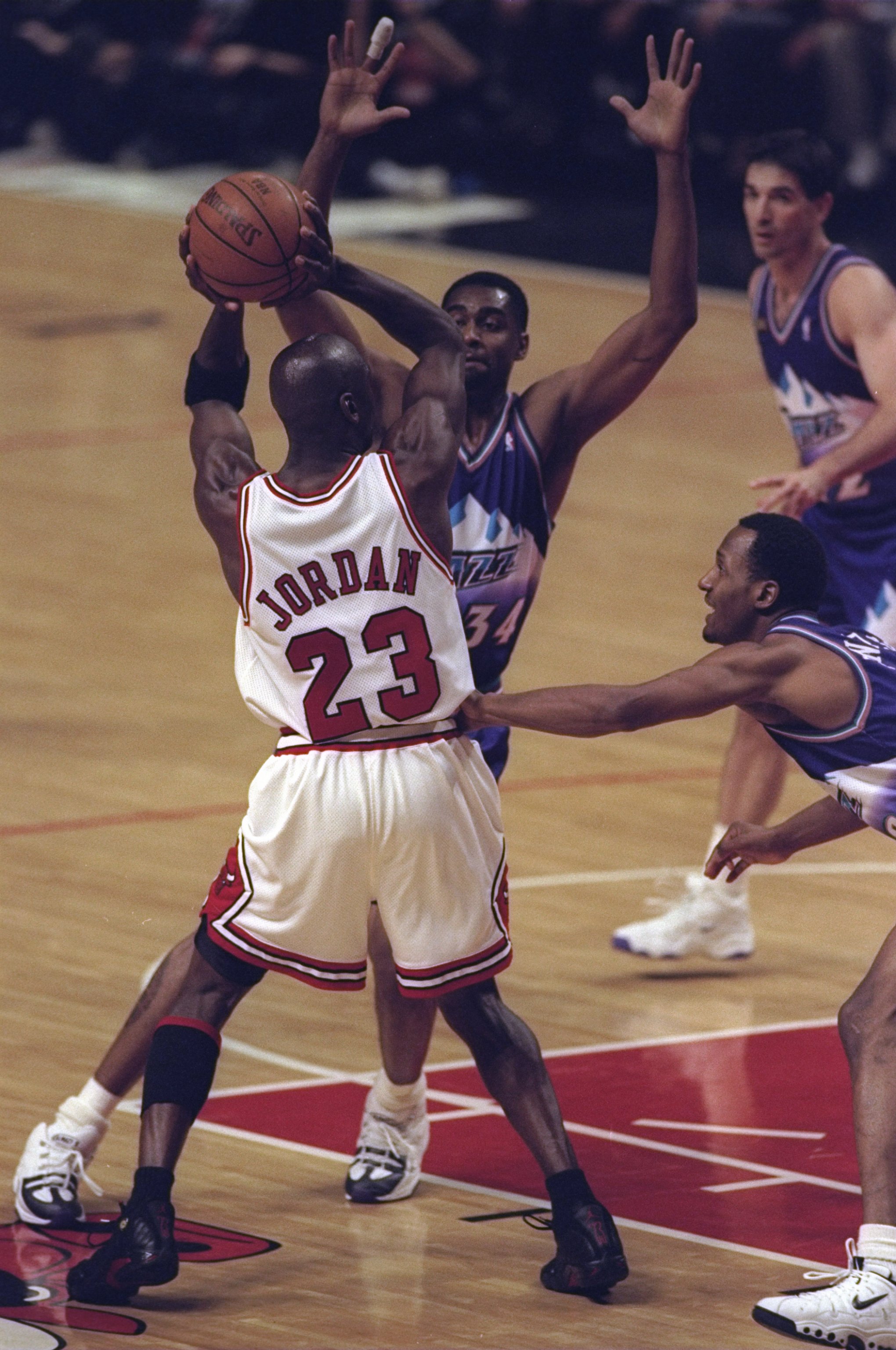 10 Jun 1998:  Michael Jordan #23 of the Chicago Bulls in action against Chris Morris and Howard Eisley of the Utah Jazz during the NBA Finals Game 4 at the United Center in Chicago, Illinois.  The Bulls defeated the Jazz 86-82. Mandatory Credit: Jonathan