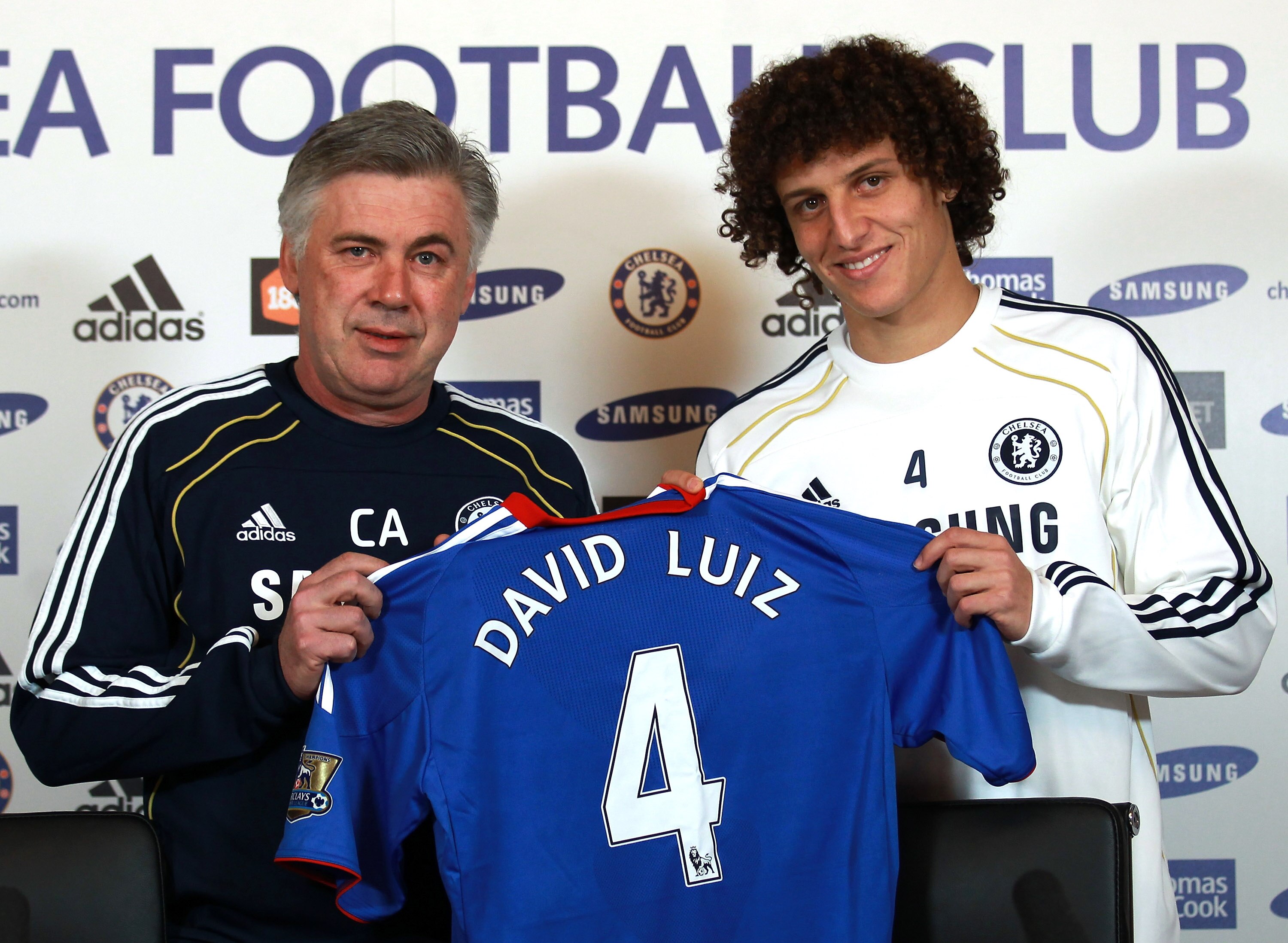 COBHAM, ENGLAND - FEBRUARY 11:  David Luiz of Chelsea is presented his shirt by Chelsea manager Carlo Ancelotti during a press conference at the Cobham training ground on February 11, 2011 in Cobham, England.  (Photo by Warren Little/Getty Images)