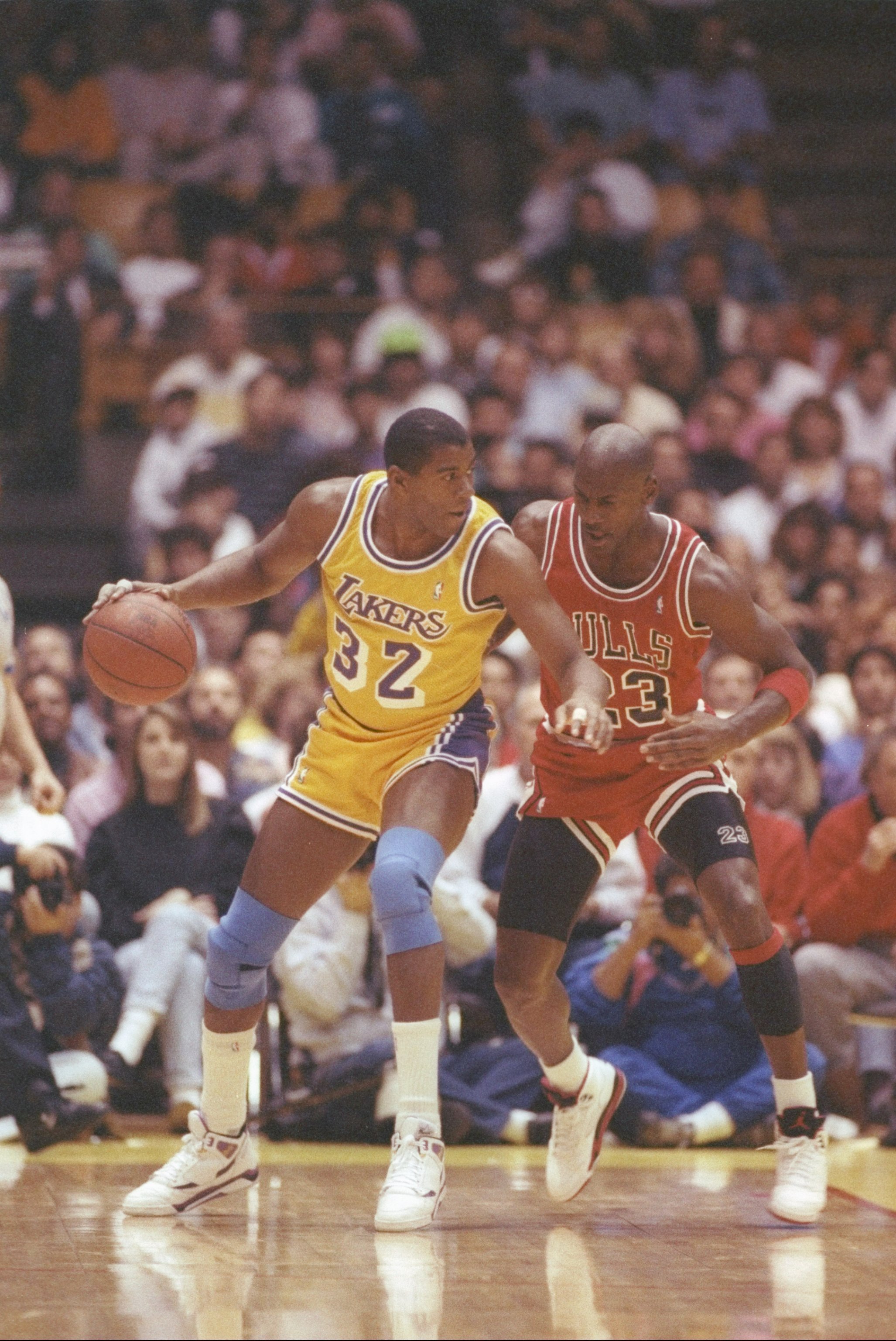 3 Feb 1991: Guard Erving Johnson of the Los Angeles Lakers dribbles the ball as guard Michael Jordan of the Chicago Bulls defends him during a game at the Great Western Forum in Inglewood, California.