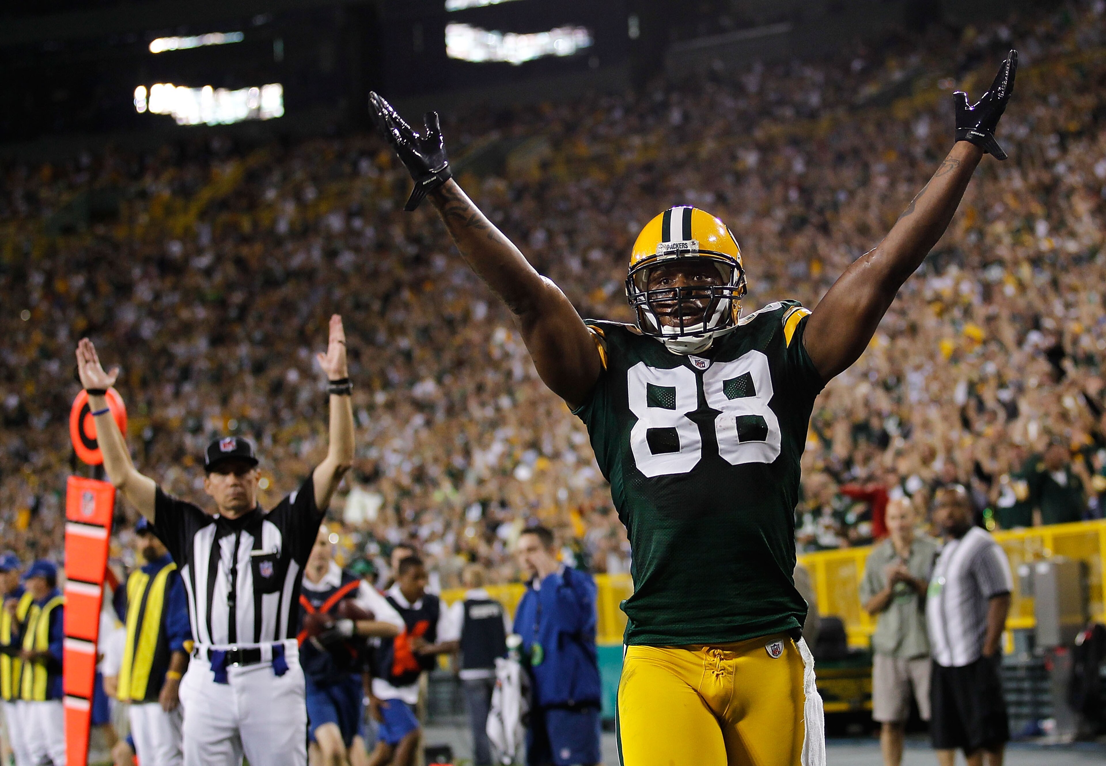 GREEN BAY, WI - AUGUST 26: Jermichael Finley #88 of the Green Bay Packers signals, along with a referee, a touchdown against the Indianapolis Colts during a preseason game at Lambeau Field on August 26, 2010 in Green Bay, Wisconsin. (Photo by Jonathan Dan GREEN BAY, WI - AUGUST 26: Jermichael Finley #88 of the Green Bay Packers signals, along with a referee, a touchdown against the Indianapolis Colts during a preseason game at Lambeau Field on August 26, 2010 in Green Bay, Wisconsin. (Photo by Jonathan Dan