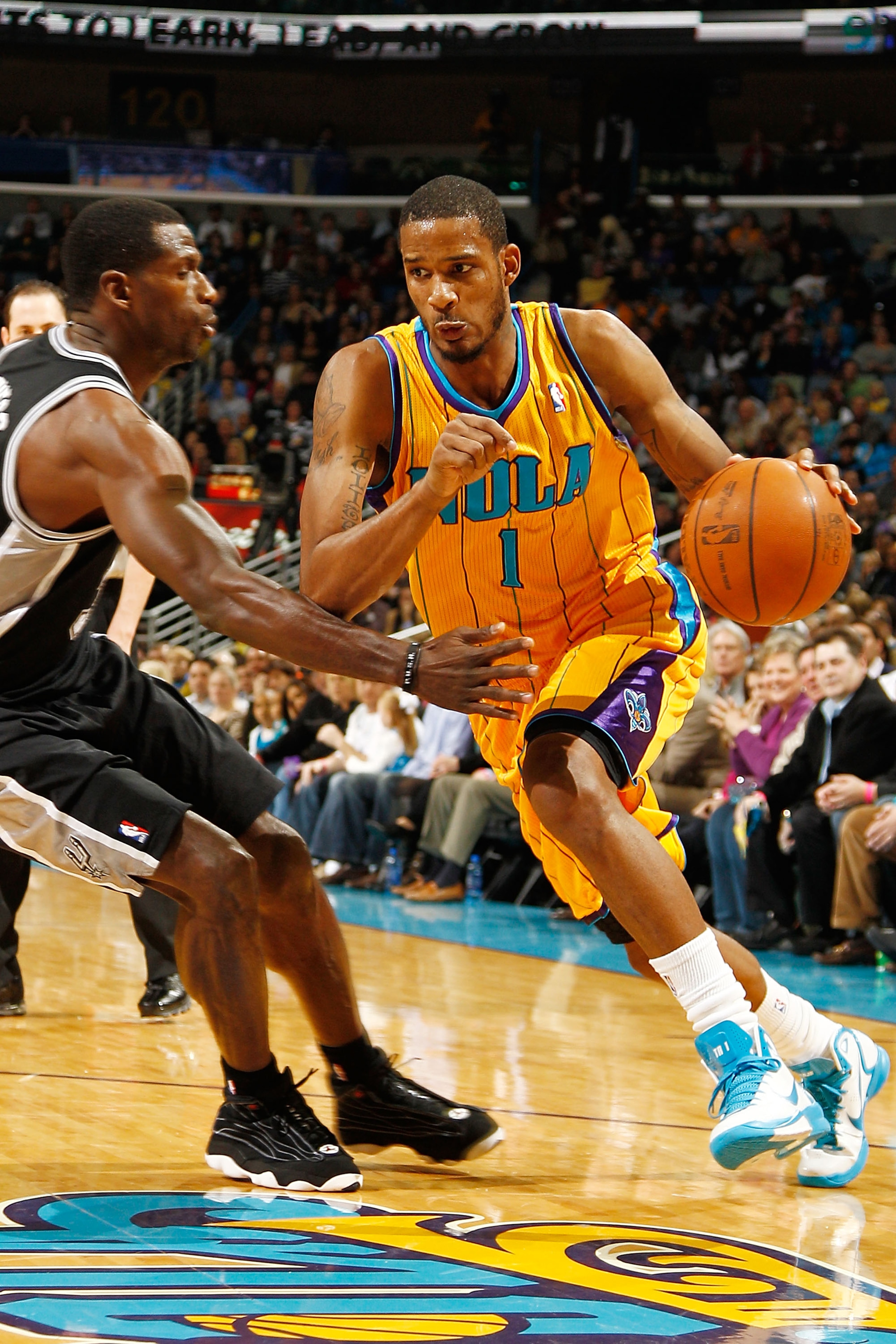 NEW ORLEANS, LA - JANUARY 22:  Trevor Ariza #1 of the New Orleans Hornets drives the ball around Antonio McDyess #34 of the San Antonio Spurs at the New Orleans Arena on January 22, 2011 in New Orleans, Louisiana.  The Hornets defeated the Spurs 96-72.  N