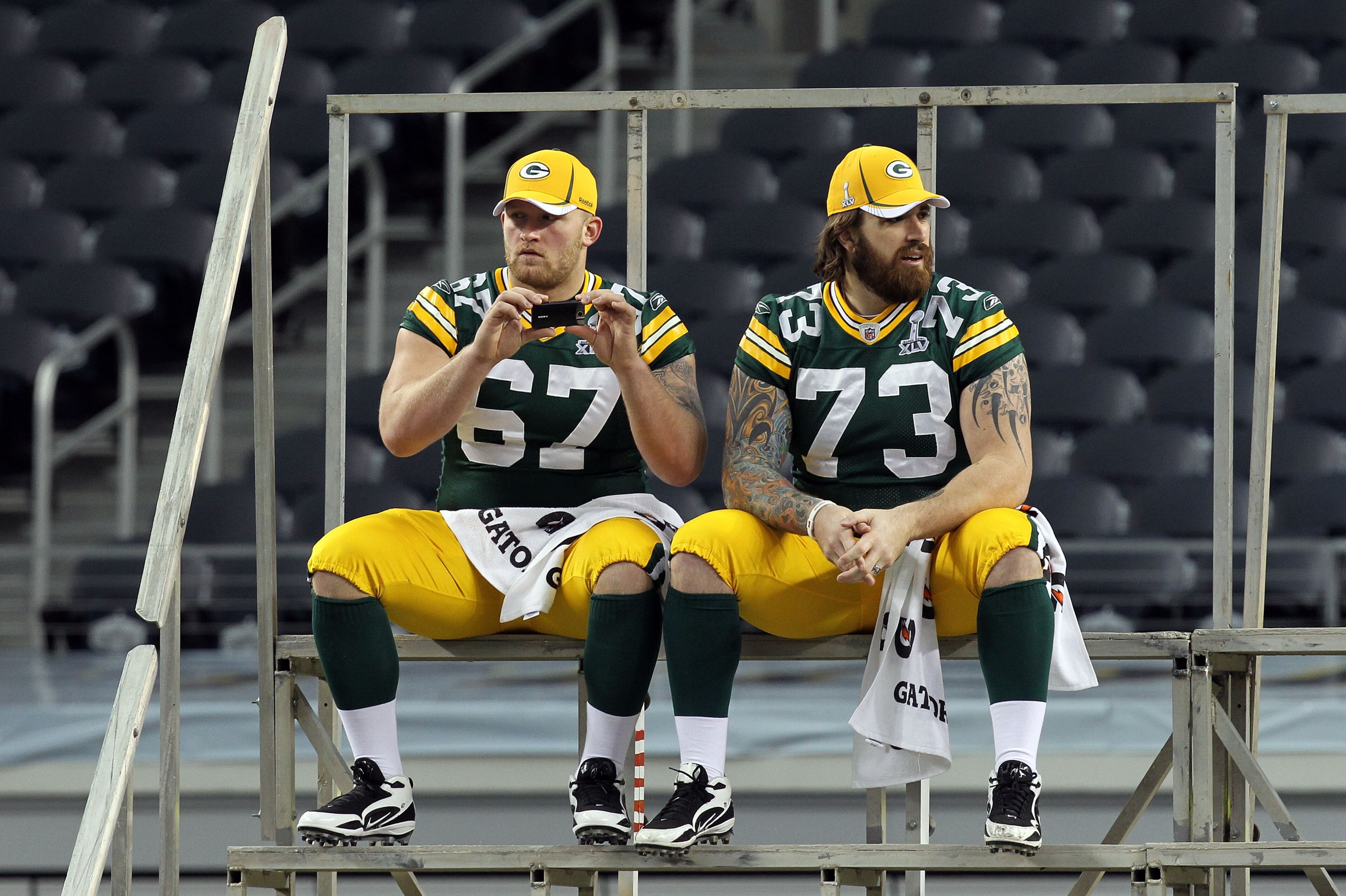 ARLINGTON, TX - FEBRUARY 01: Nick McDonald #67 and Daryn Colledge #73 of the Green Bay Packers wait for the start of Super Bowl XLV Media Day ahead of Super Bowl XLV at Cowboys Stadium on February 1, 2011 in Arlington, Texas. The Pittsburgh Steelers will ARLINGTON, TX - FEBRUARY 01: Nick McDonald #67 and Daryn Colledge #73 of the Green Bay Packers wait for the start of Super Bowl XLV Media Day ahead of Super Bowl XLV at Cowboys Stadium on February 1, 2011 in Arlington, Texas. The Pittsburgh Steelers will
