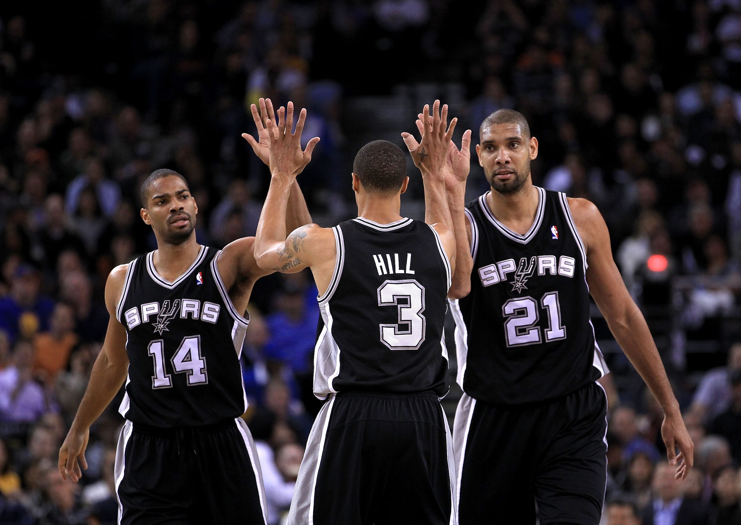 OAKLAND, CA - JANUARY 24: George Hill #3 of the San Antonio Spurs is congratulated by Tim Duncan #21 and Gary Neal #14 after Hill got fouled during their game against the Golden State Warriors at Oracle Arena on January 24, 2011 in Oakland, California. OAKLAND, CA - JANUARY 24: George Hill #3 of the San Antonio Spurs is congratulated by Tim Duncan #21 and Gary Neal #14 after Hill got fouled during their game against the Golden State Warriors at Oracle Arena on January 24, 2011 in Oakland, California.