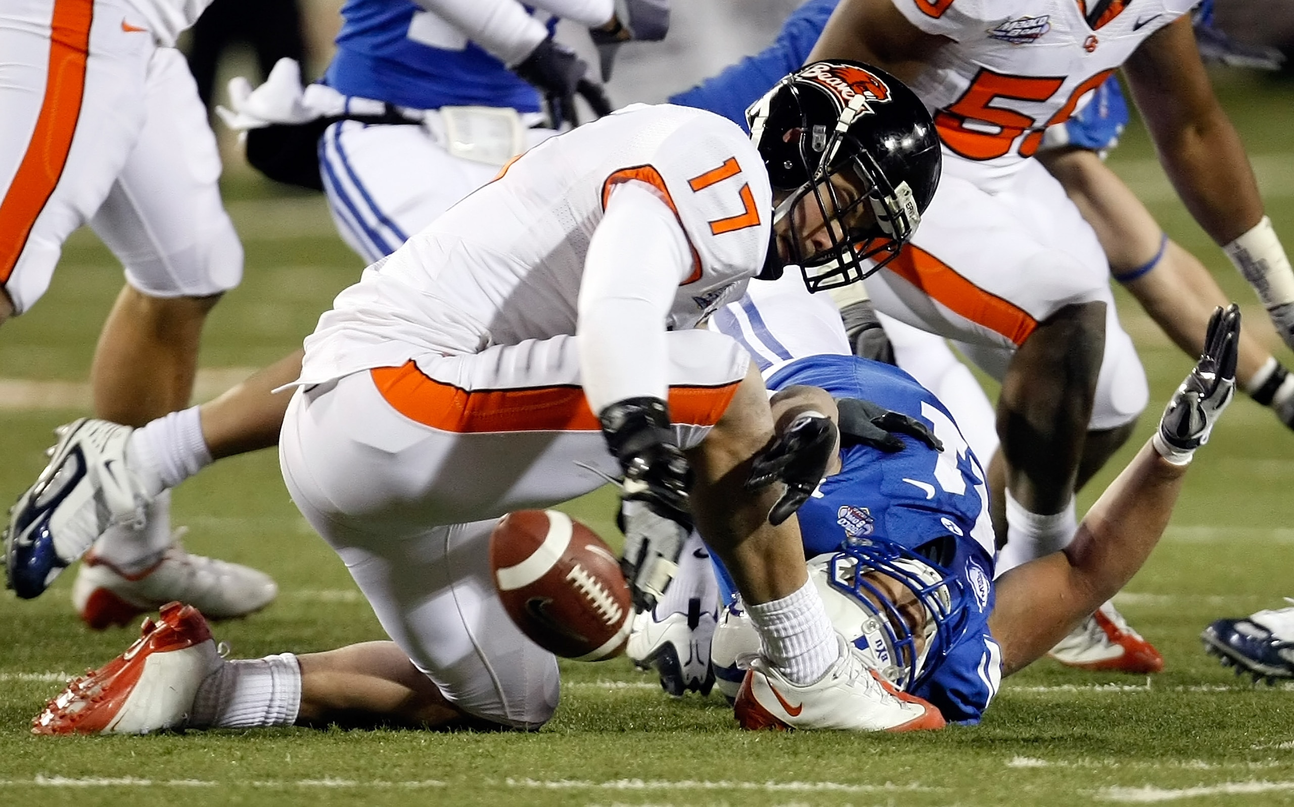 LAS VEGAS - DECEMBER 22:  Brandon Hardin #17 of the Oregon State Beavers tries to recover the ball after Manase Tonga #11 of the Brigham Young University Cougars dropped it during an onside kick by the Beavers during the fourth quarter of the MAACO Las Ve