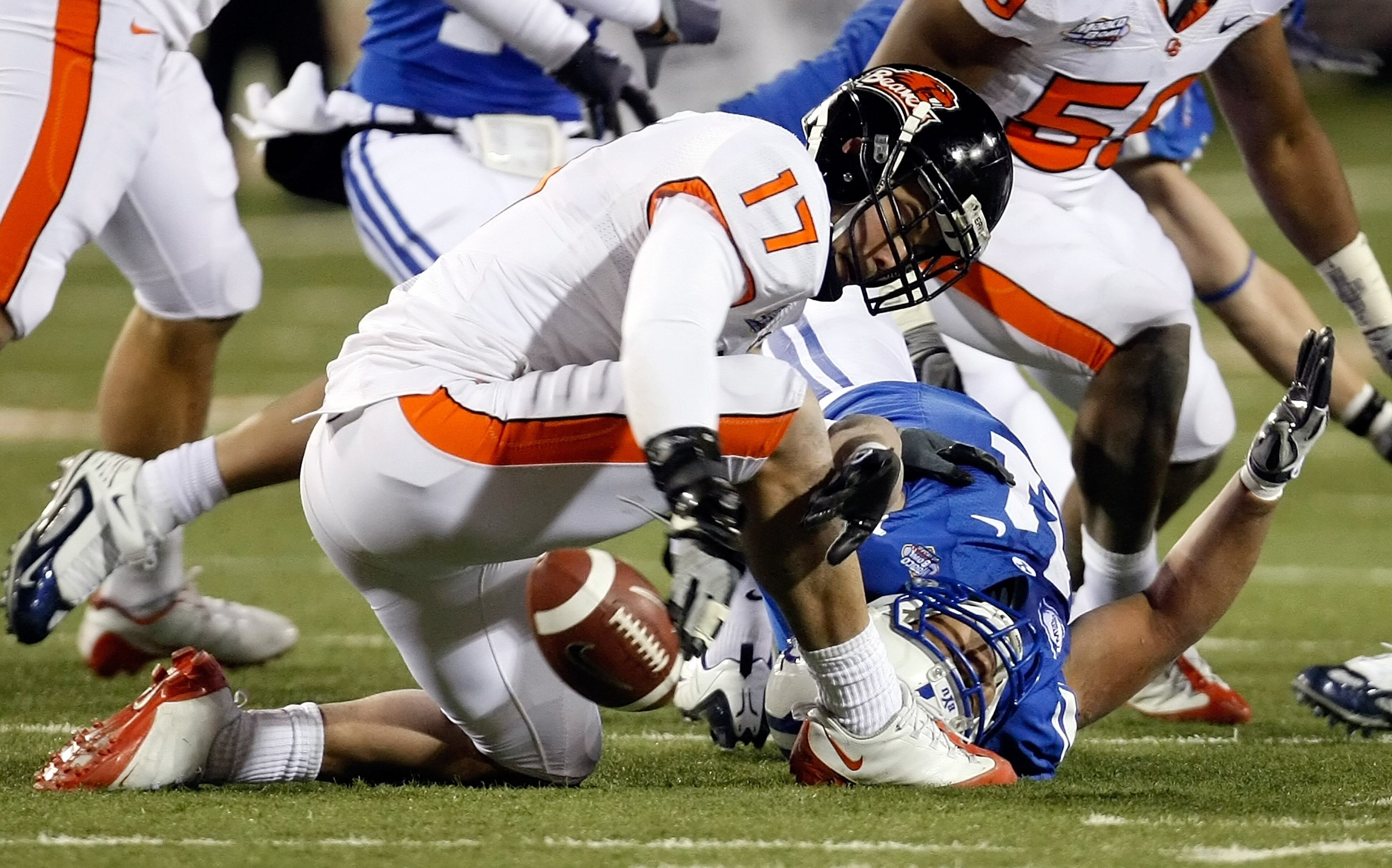 LAS VEGAS - DECEMBER 22:  Brandon Hardin #17 of the Oregon State Beavers tries to recover the ball after Manase Tonga #11 of the Brigham Young University Cougars dropped it during an onside kick by the Beavers during the fourth quarter of the MAACO Las Ve