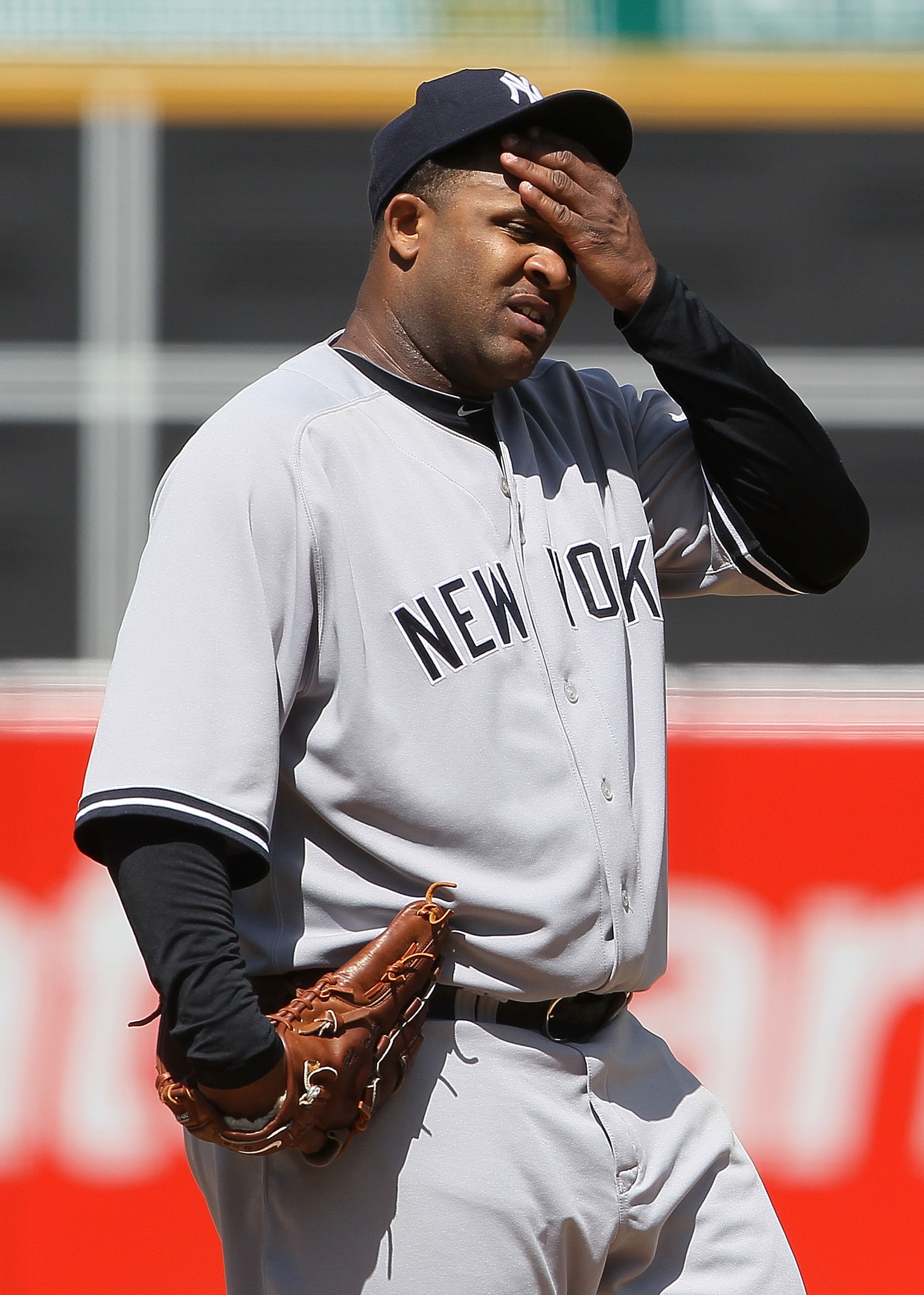 OAKLAND, CA - APRIL 22:  C.C. Sabathia #52 of the New York Yankees wipes his forehead during the eighth inning against the Oakland Athletics at the Oakland-Alameda County Coliseum on April 22, 2010 in Oakland, California. The Athletics defeated the Yankee