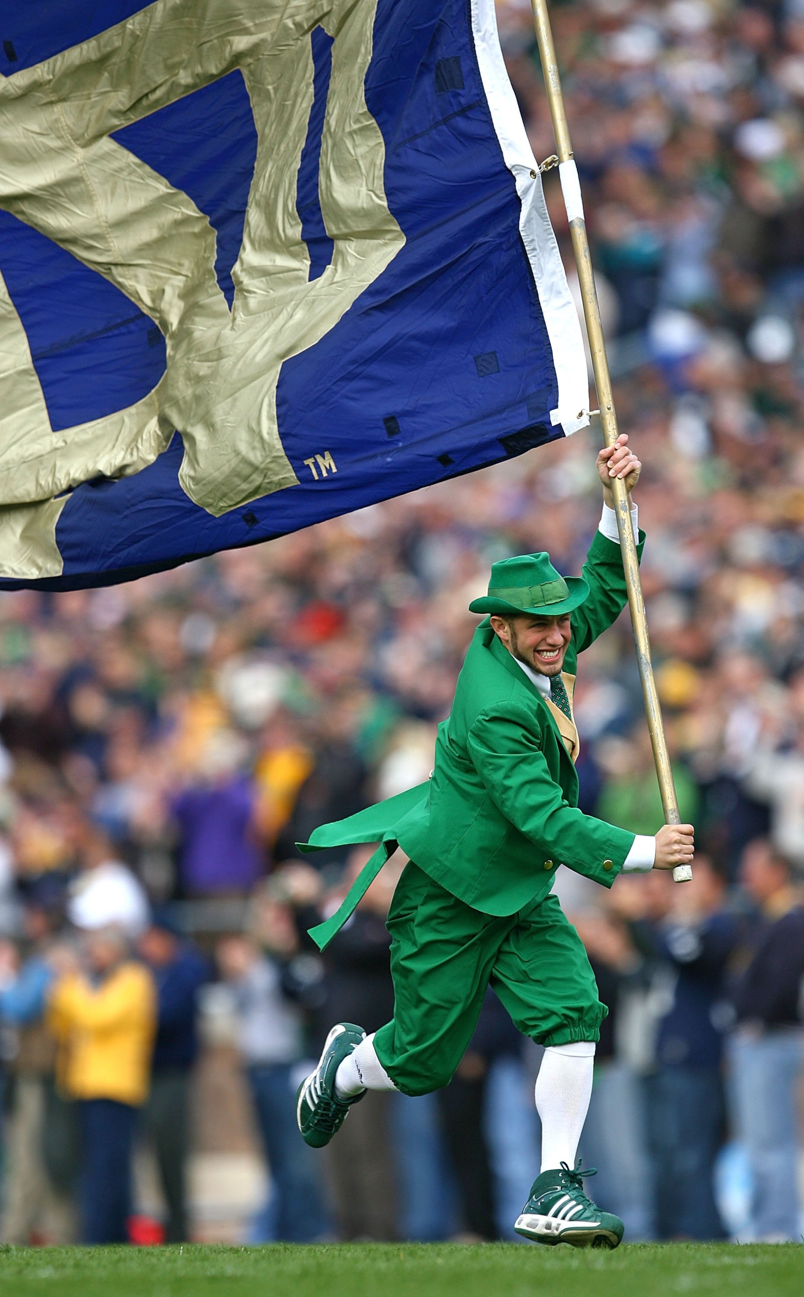 SOUTH BEND, IN - OCTOBER 03: The leprechaun mascot for the Notre Dame Fighting Irish runs onto the field with a flag before a game against the Washington Huskies on October 3, 2009 at Notre Dame Stadium in South Bend, Indiana. Notre Dame defeated Washingt SOUTH BEND, IN - OCTOBER 03: The leprechaun mascot for the Notre Dame Fighting Irish runs onto the field with a flag before a game against the Washington Huskies on October 3, 2009 at Notre Dame Stadium in South Bend, Indiana. Notre Dame defeated Washingt