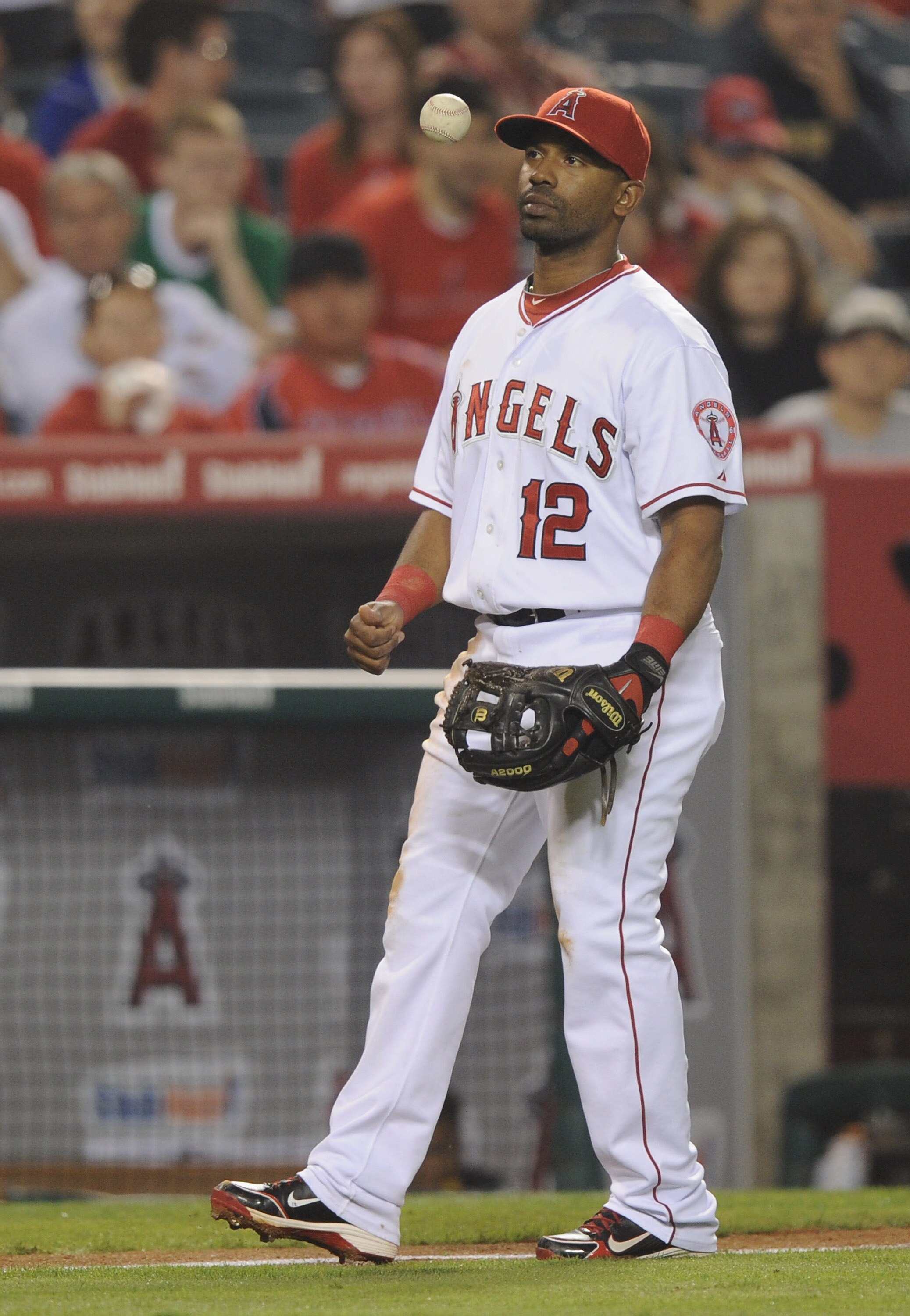 ANAHEIM, CA - SEPTEMBER 20:  Alberto Callaspo #12 of Los Angeles Angels of Anaheim reacts after picking up the ball from an infield hit by Vladimir Guerrero #27 of the Texas Ranger during the fourth inning at Angel Stadium on September 20, 2010 in Anaheim