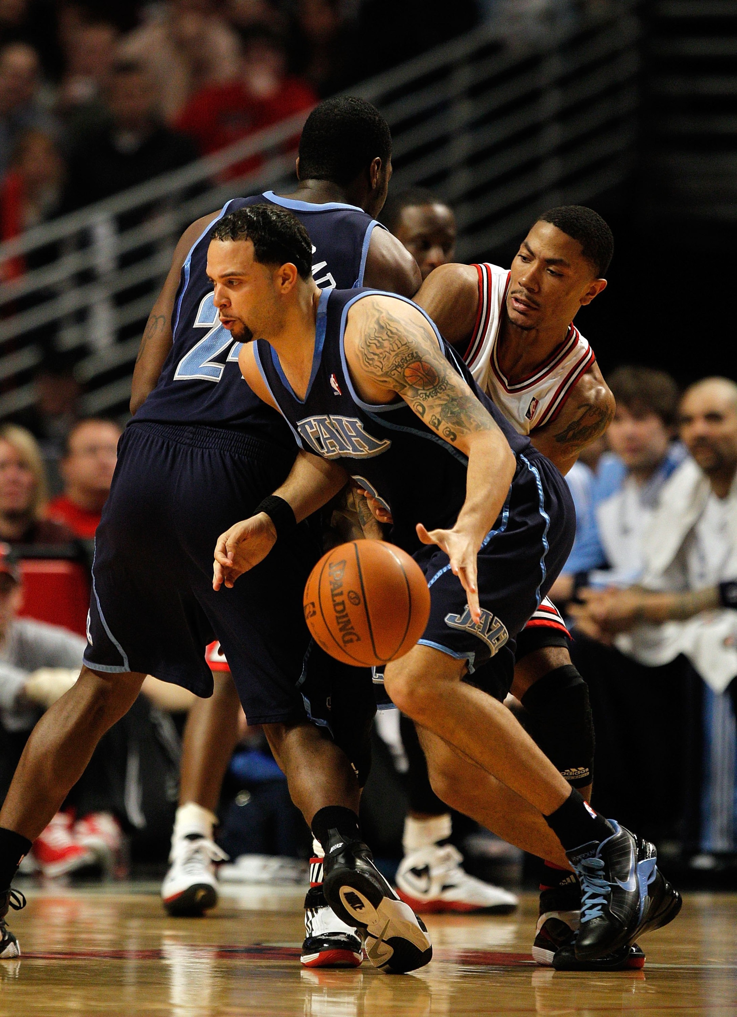 CHICAGO - MARCH 09: Deron Williams #8 of the Utah Jazz moves around a screen set by teammate Paul Millsap #24 on Derrick Rose #1 of the Chicago Bulls at the United Center on March 9, 2010 in Chicago, Illinois. The Jazz defeated the Bulls 132-108. NOTE TO