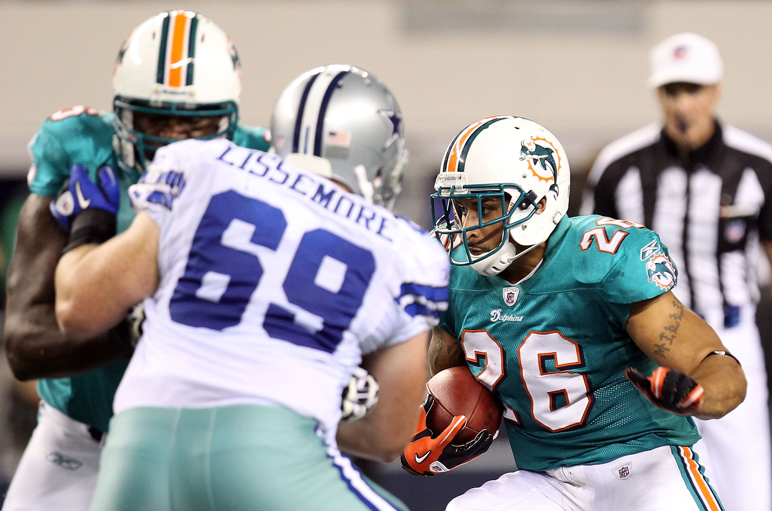 Miami Dolphins running back Kory Sheets (23) breaks the tackle of