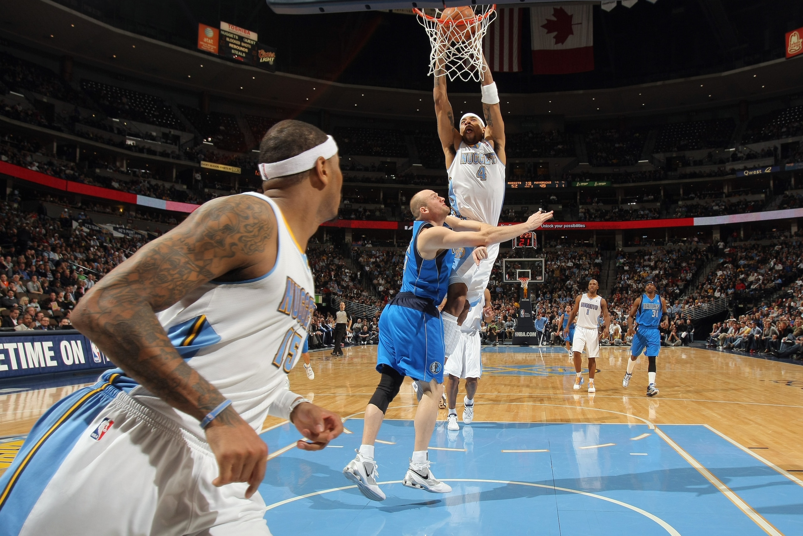 DENVER, CO - FEBRUARY 10:  Kenyon Martin #4 of the Denver Nuggets dunks the ball against Brian Cardinal #35 of the Dallas Mavericks as Carmelo Anthony #15 of the Nuggets follows the play during NBA action at the Pepsi Center on February 10, 2011 in Denver