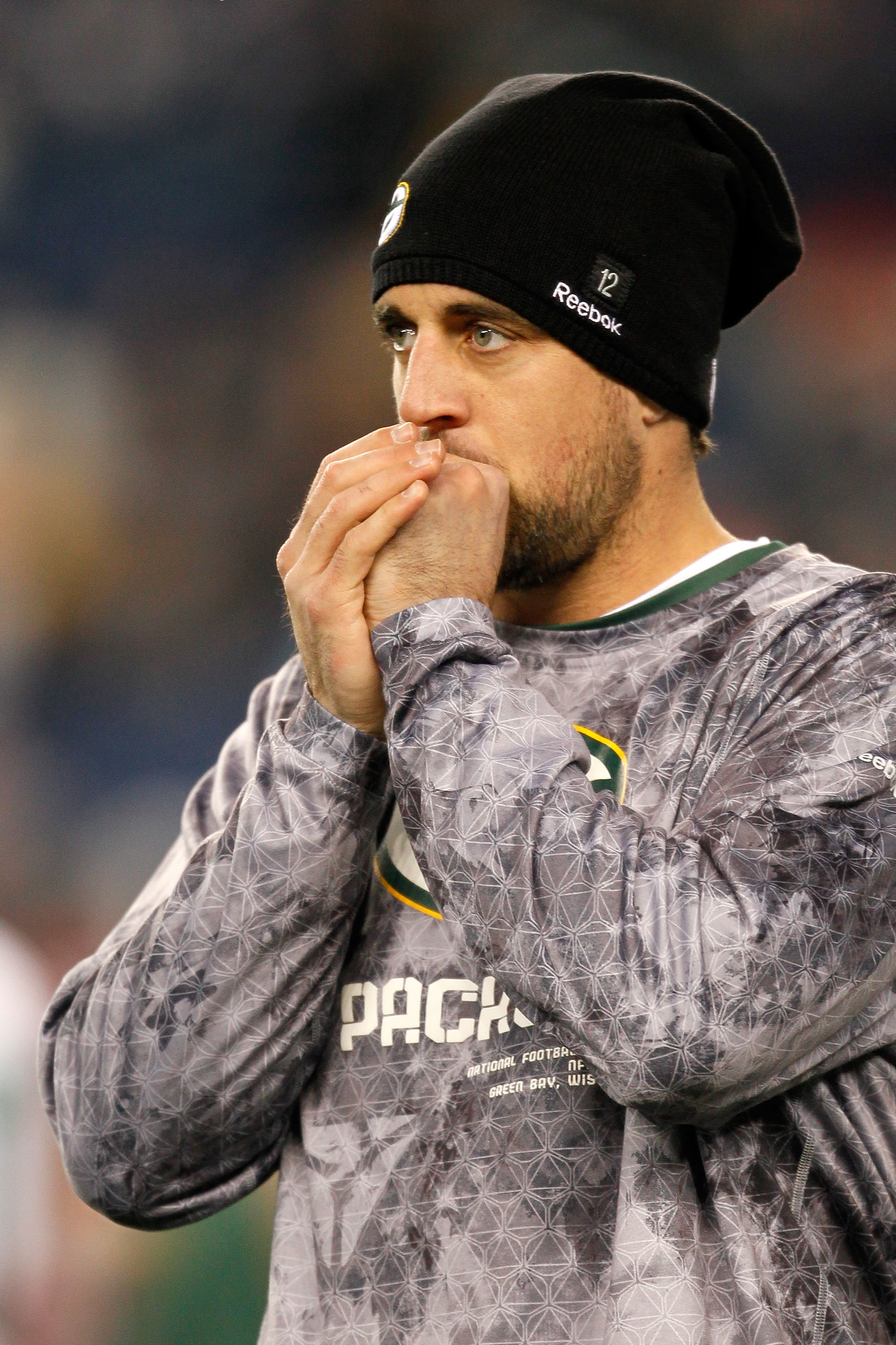 FOXBORO, MA - DECEMBER 19:  Quarterback Aaron Rodgers #12 of the Green Bay Packers, inactive due to an injury, looks on during warm-ups before the game against the New England Patriots at Gillette Stadium on December 19, 2010 in Foxboro, Massachusetts.  (