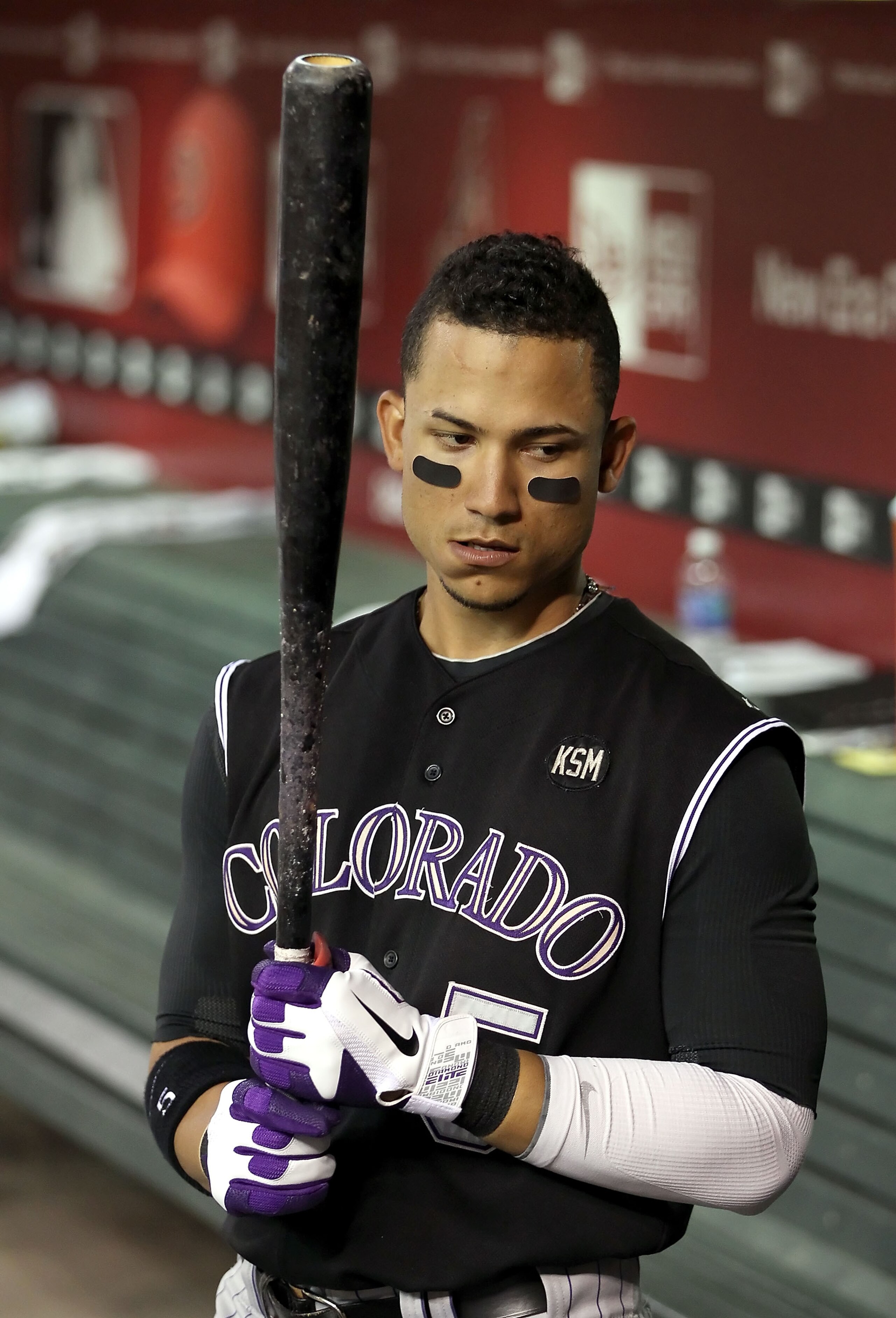 PHOENIX - SEPTEMBER 22:  Carlos Gonzalez #5 of the Colorado Rockies warms up in the dugout during the Major League Baseball game against the Arizona Diamondbacks at Chase Field on September 22, 2010 in Phoenix, Arizona.  (Photo by Christian Petersen/Getty