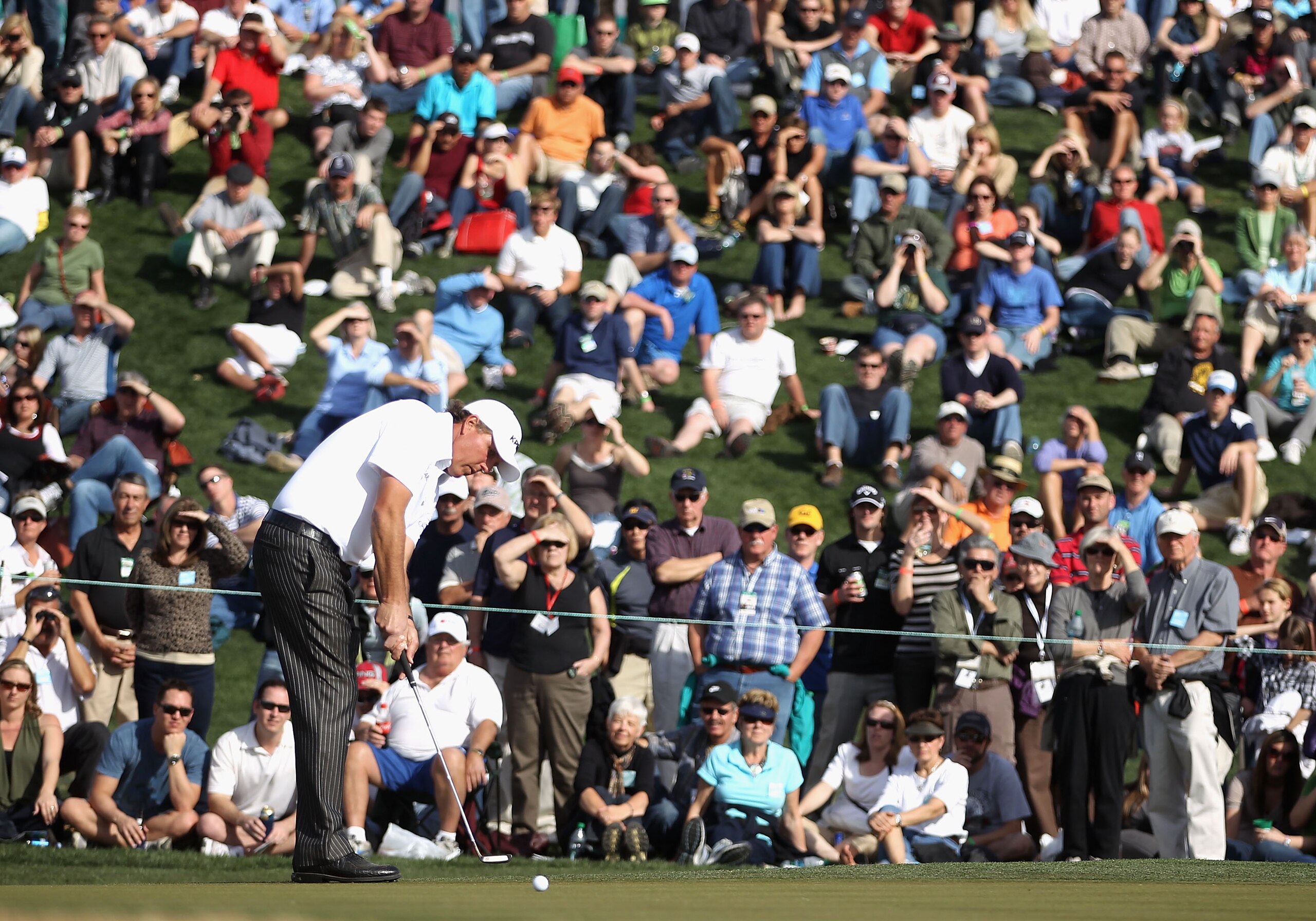SCOTTSDALE, AZ - FEBRUARY 06:  Phil Mickelson hits putts on the second hole green during the final round of the Waste Management Phoenix Open at TPC Scottsdale on February 6, 2011 in Scottsdale, Arizona.  (Photo by Christian Petersen/Getty Images)