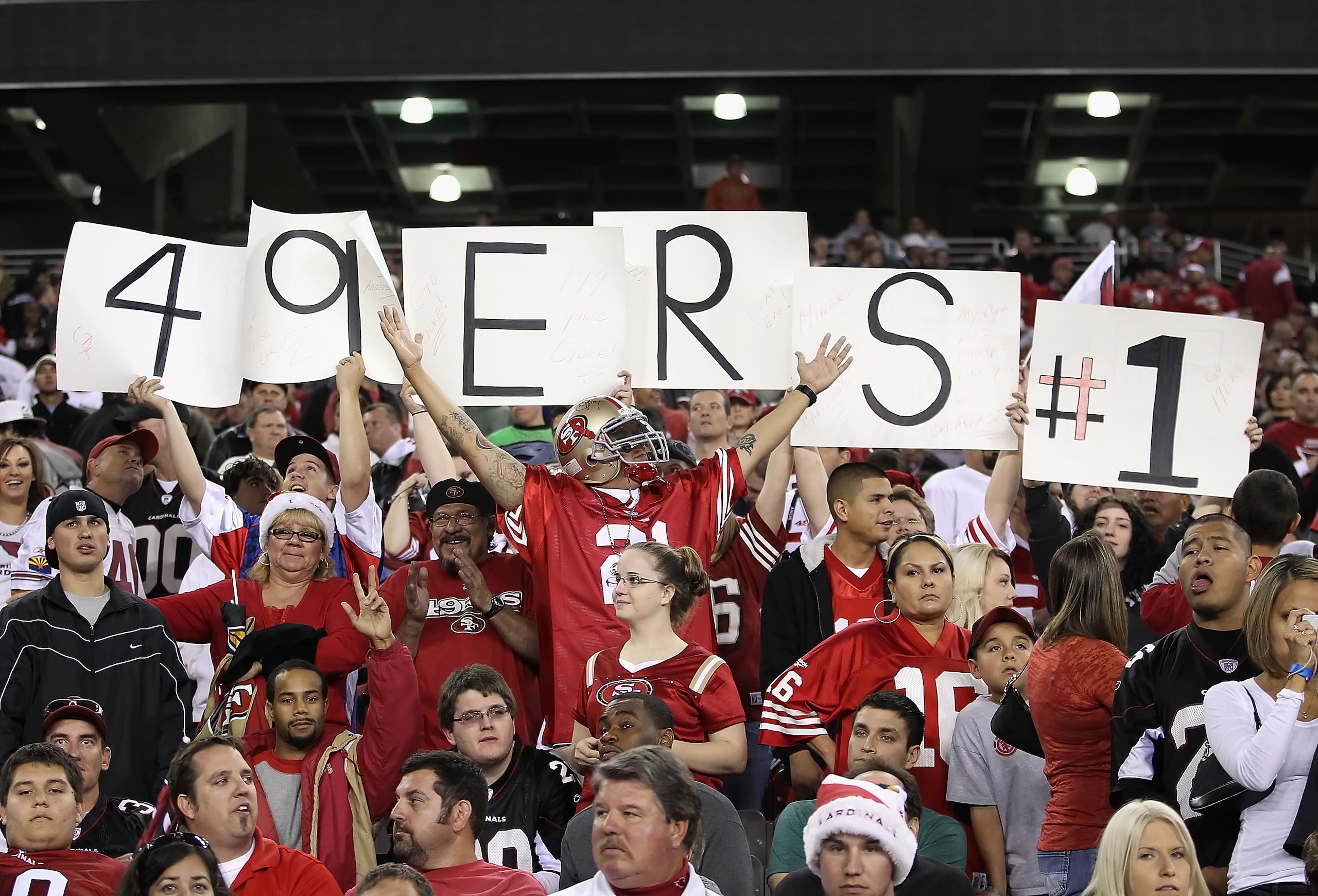 GLENDALE, AZ - NOVEMBER 29: Fans of the San Francisco 49ers hold up signs and cheer during the NFL game against the Arizona Cardinals at the University of Phoenix Stadium on November 29, 2010 in Glendale, Arizona. The 49ers defeated the Cardinals 27-6. GLENDALE, AZ - NOVEMBER 29: Fans of the San Francisco 49ers hold up signs and cheer during the NFL game against the Arizona Cardinals at the University of Phoenix Stadium on November 29, 2010 in Glendale, Arizona. The 49ers defeated the Cardinals 27-6.